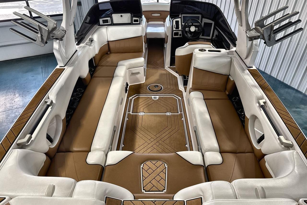 Luxurious interior of a 2020 Supra SE boat with elegant brown and white seating.