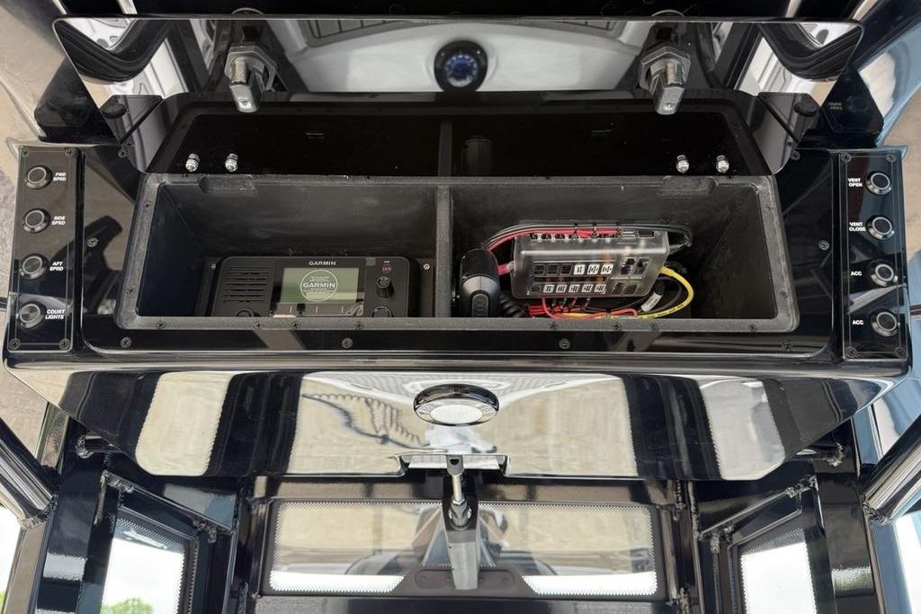 2026 Tidewater 2500 Carolina Bay electronics compartment with Garmin device and wiring.