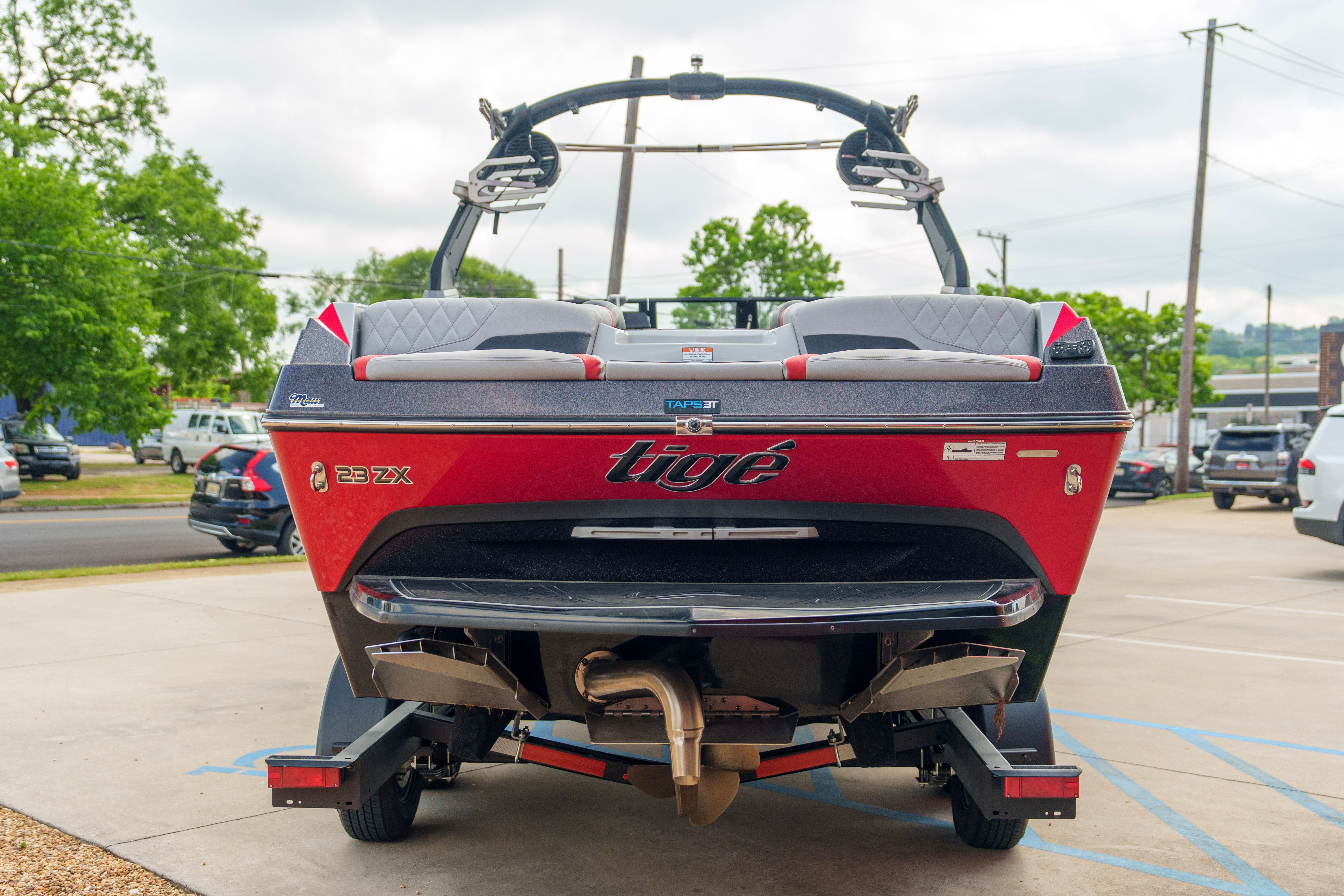 Red 2020 Tigé 23ZX boat parked in a lot.