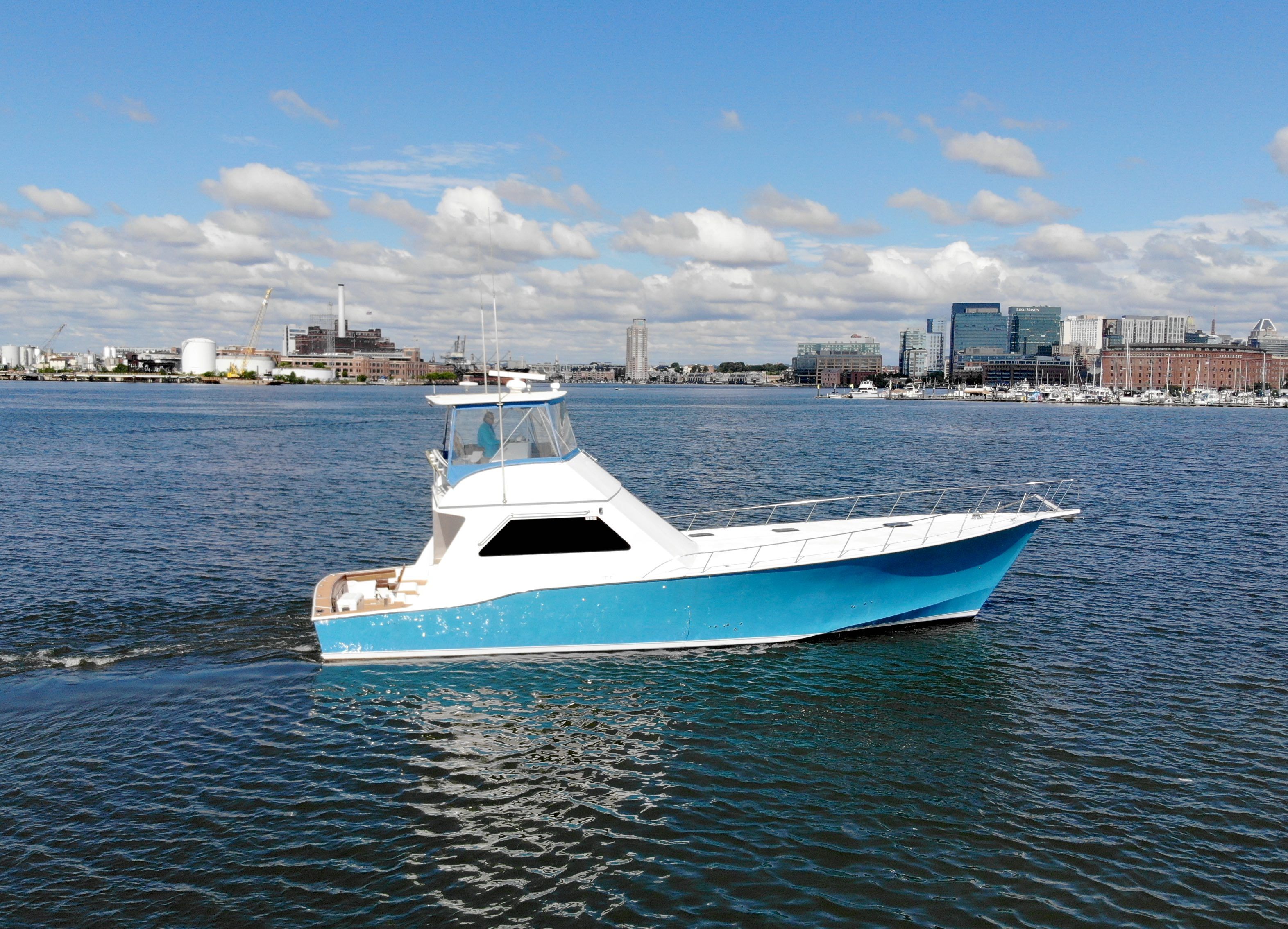 2004 Chesapeake 58 boat on calm water with city skyline.