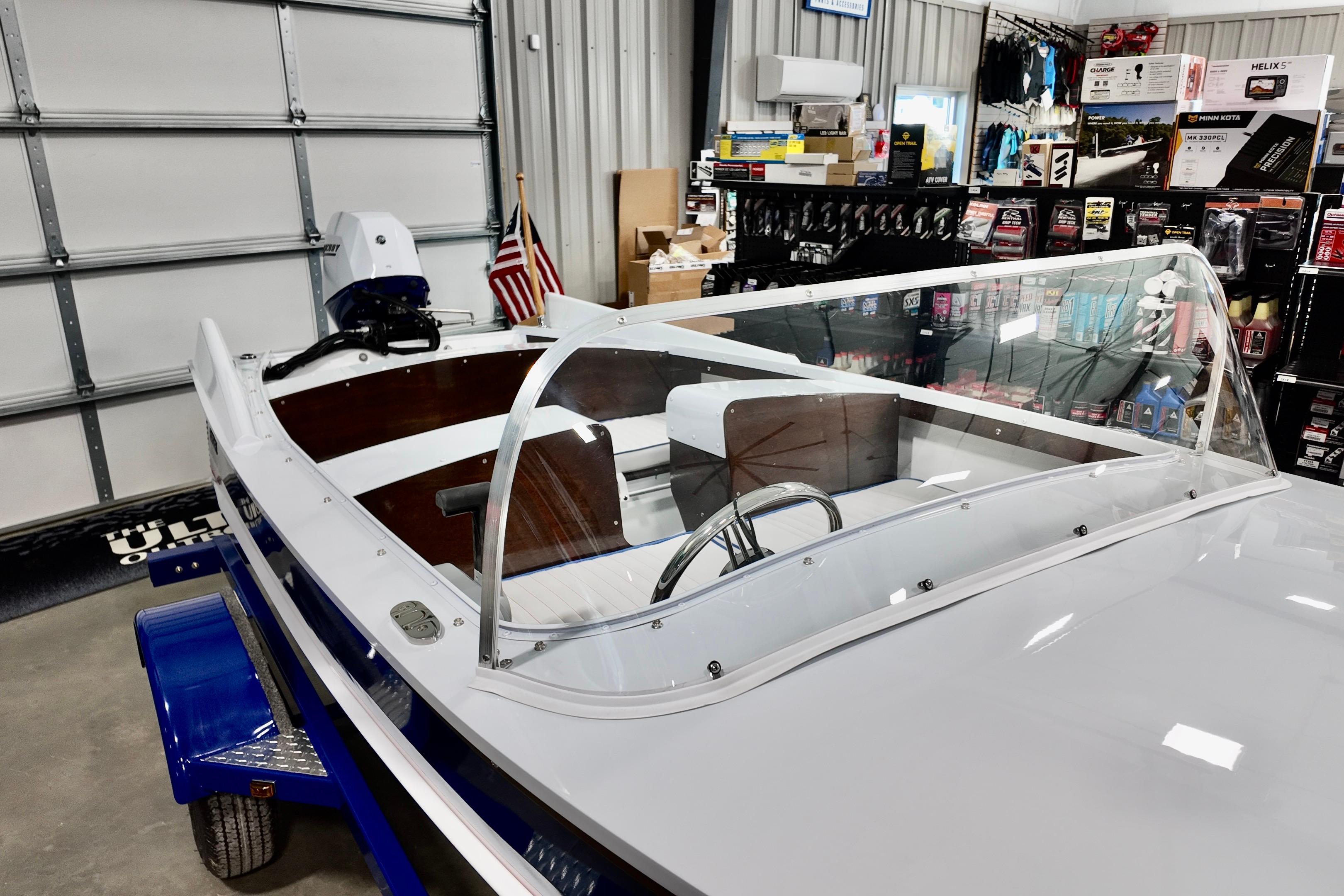 2026 Starcraft 57 Ski Champ boat displayed in a showroom with accessories.