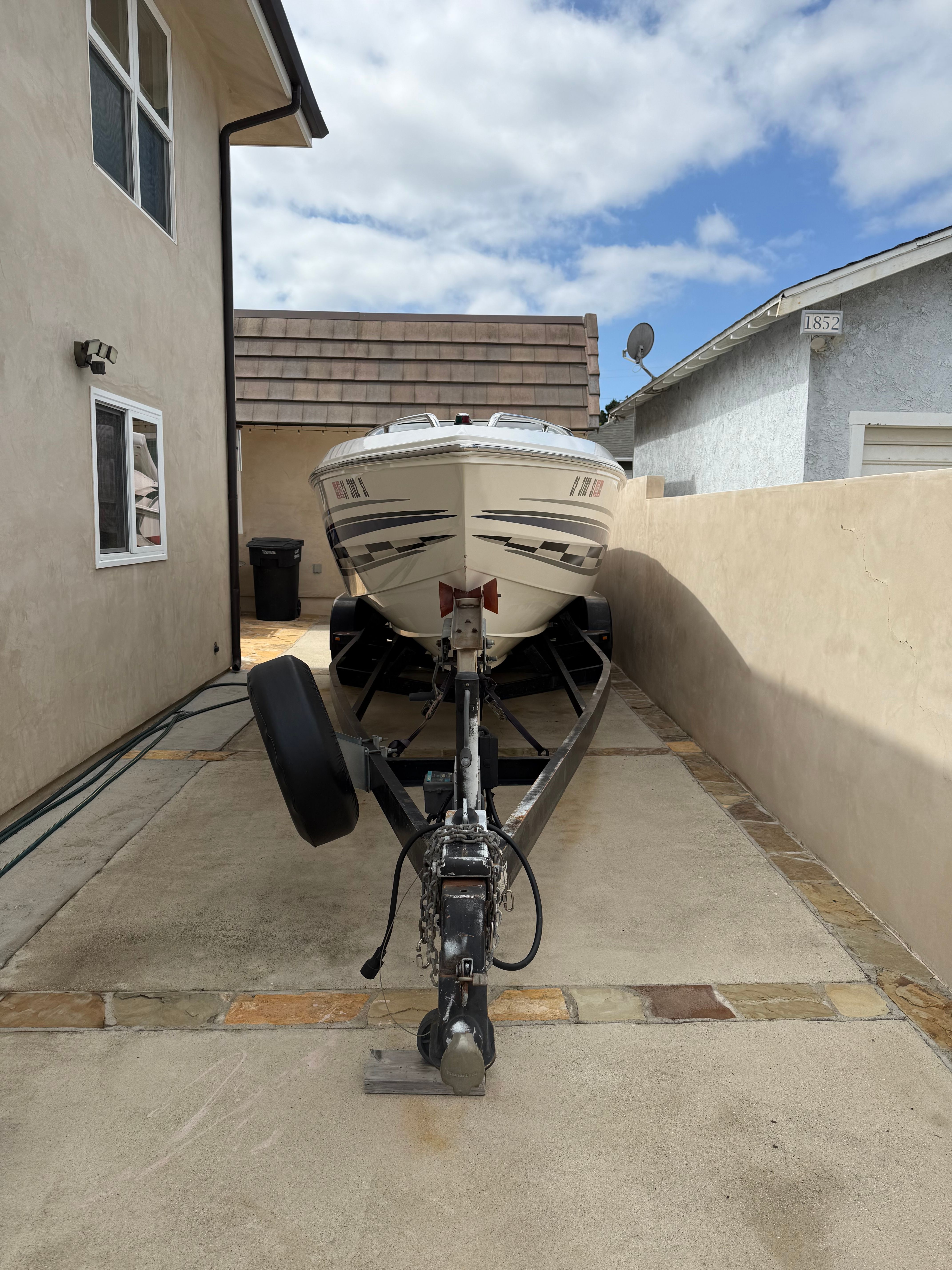 2001 Wellcraft 29 Scarab on trailer in driveway.