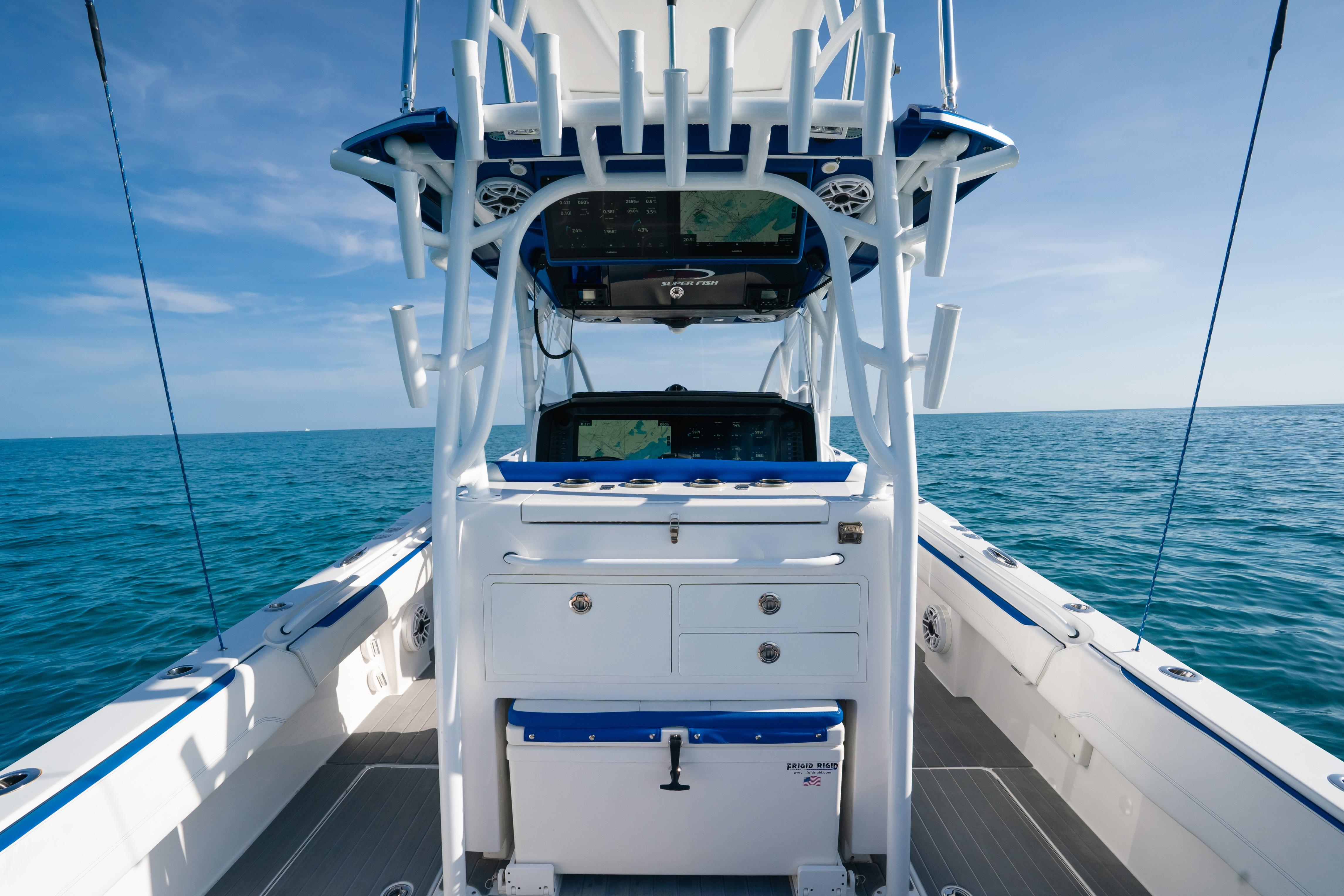 2022 Nor-Tech 392 Super Fish boat interior with ocean view, featuring advanced navigation equipment.