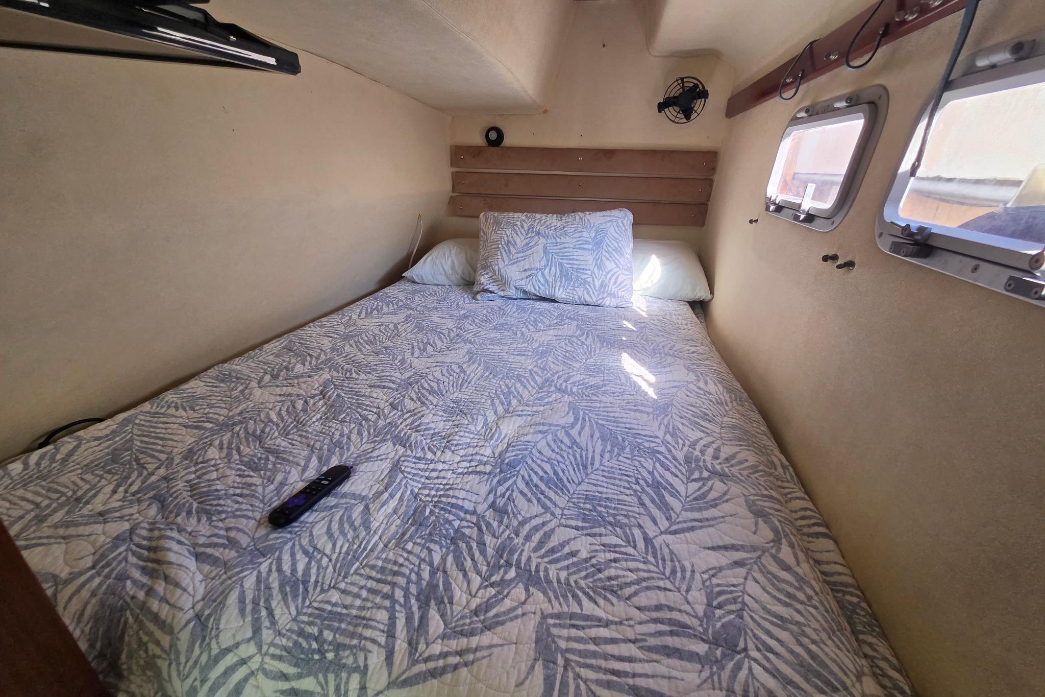 Cozy cabin bedroom in 2000 Fountaine Pajot Maryland 37 yacht with patterned bedding.