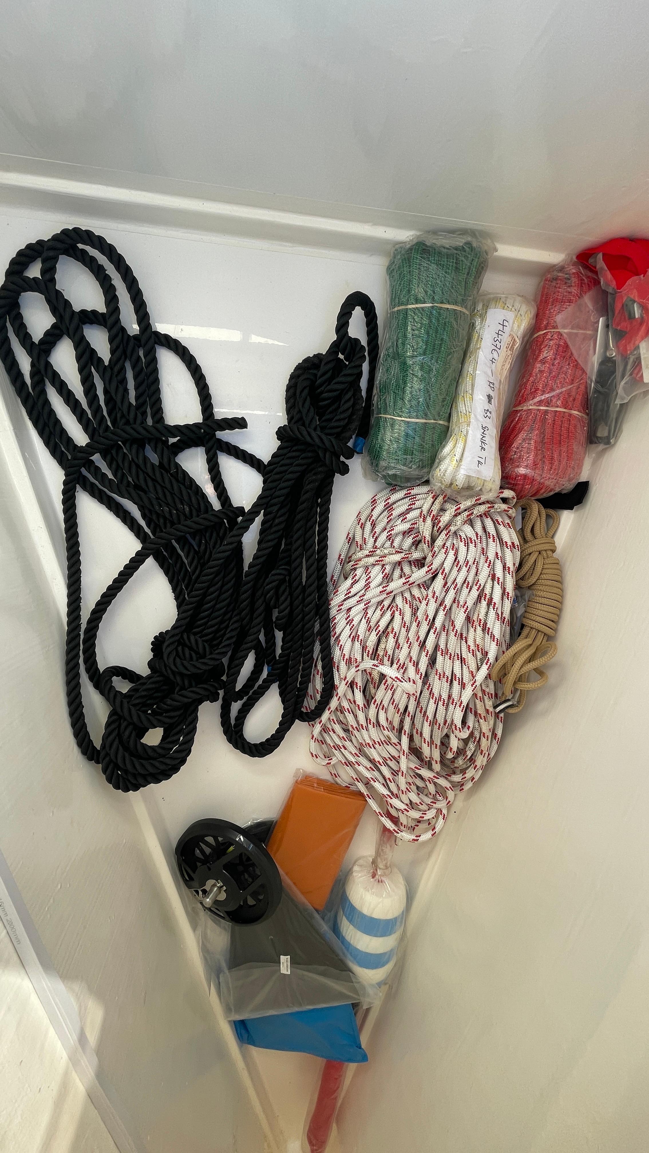 Assorted ropes and supplies in a Leopard 42 boat storage compartment, 2022 model.