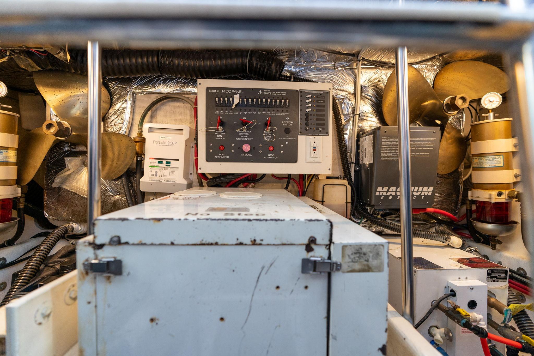 Engine room of a 1998 Tiara Yachts 3500 Express with control panel and equipment.