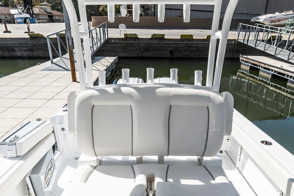 2026 Sea Hunt Gamefish 28 Coffin Box boat interior with white seating at dock.
