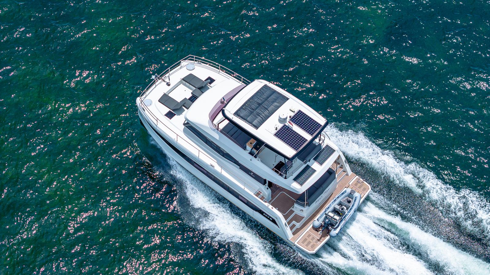 2022 Fountaine Pajot MY6 yacht cruising on open water, aerial view.