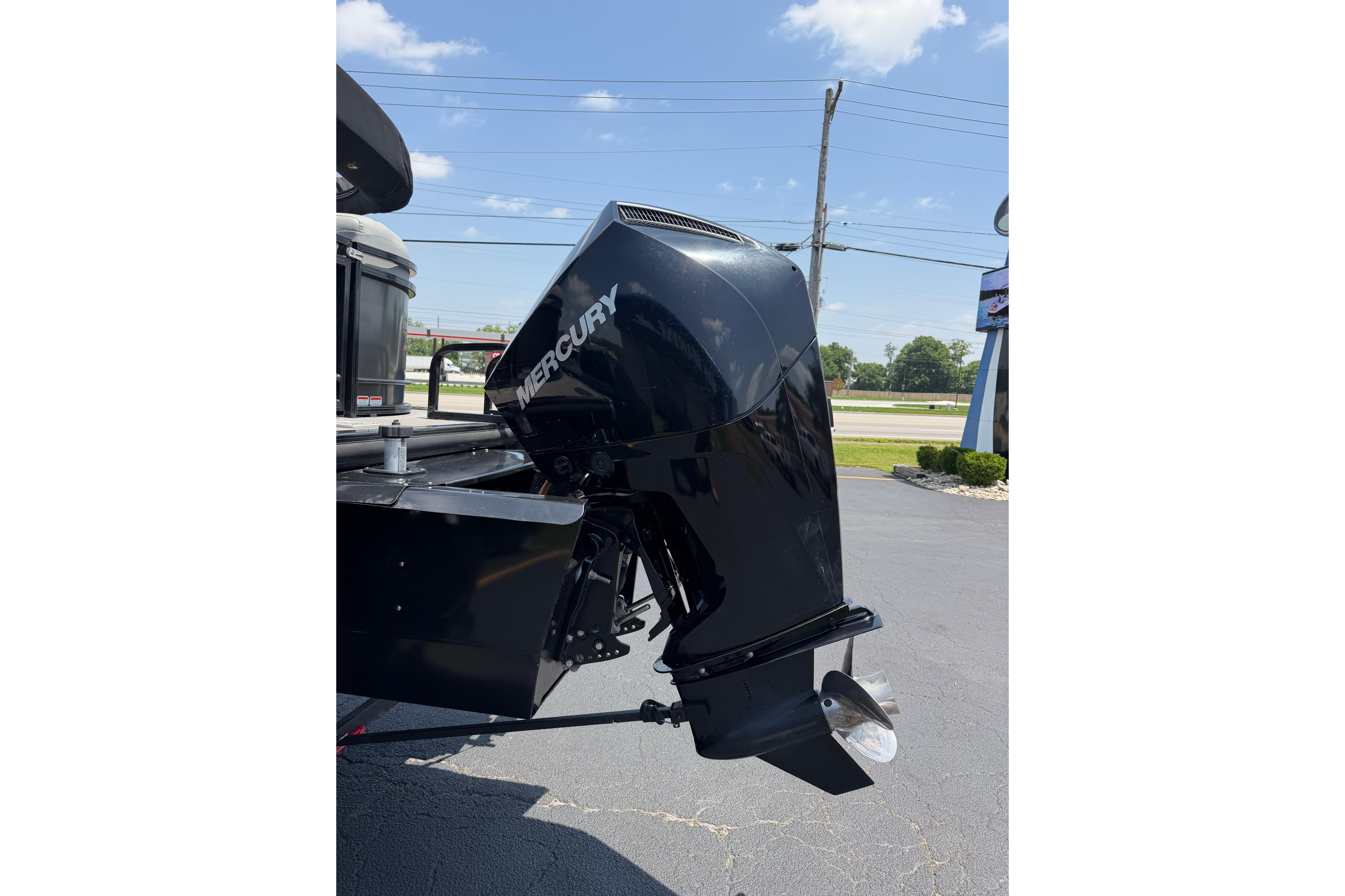 2019 Regency 230 DL3 boat with Mercury outboard motor in a parking lot.
