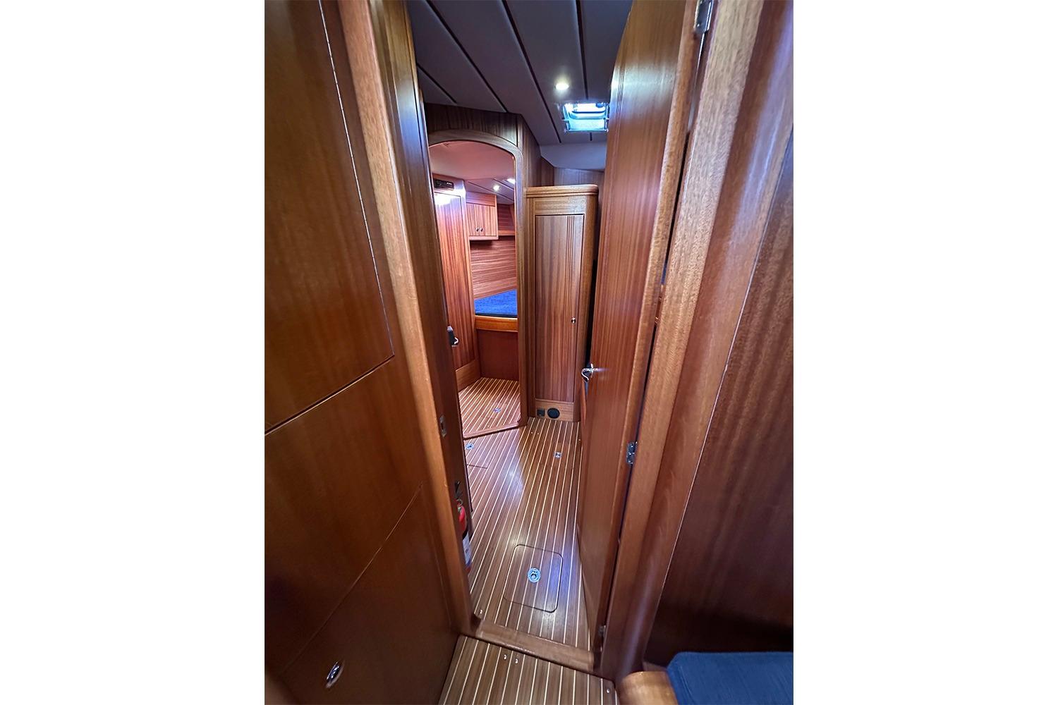 Interior of 2004 Najad 460 yacht, featuring wooden paneling and cozy cabin space.