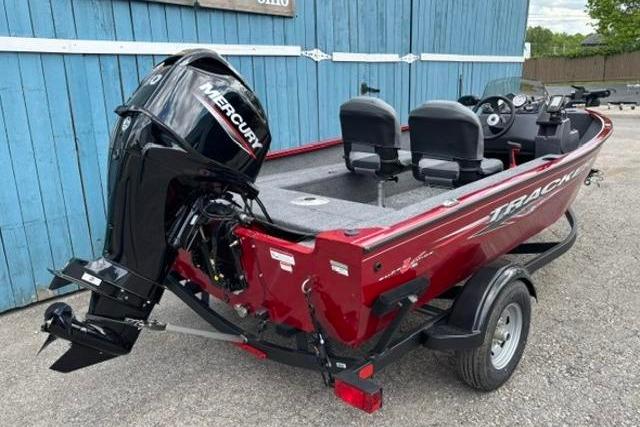 2025 Tracker Super Guide V-16 SC boat with Mercury engine, parked on a trailer.