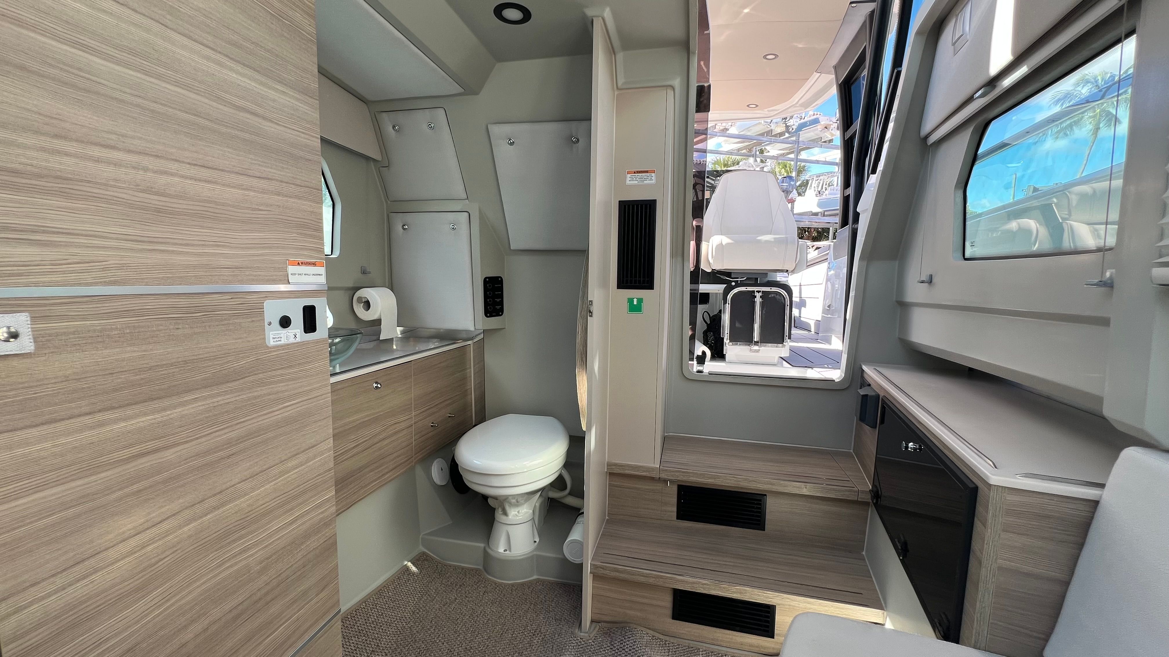 Interior of 2024 Saxdor 320 GTO featuring toilet and seating area.