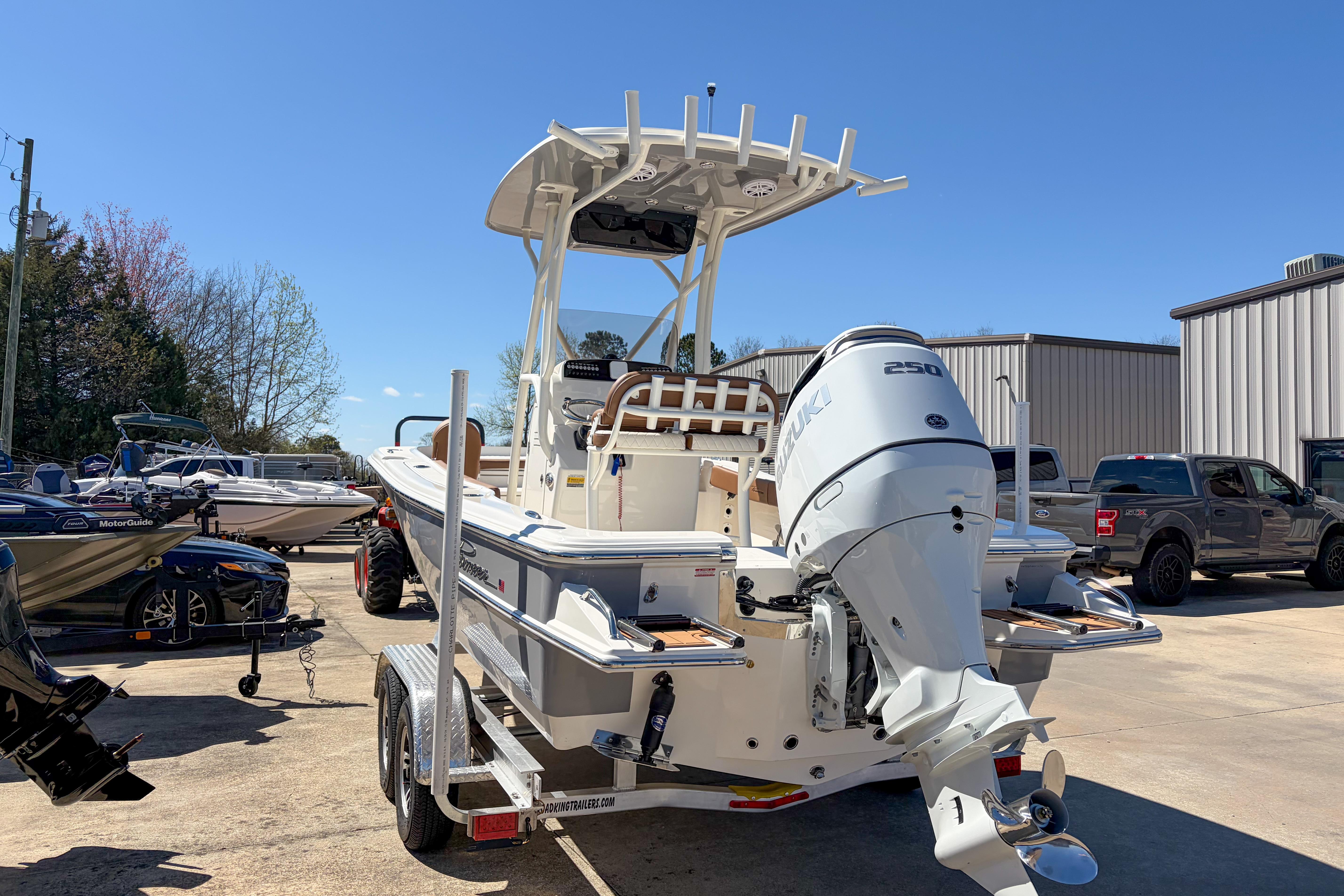 2026 Pioneer 220 Bay Sport boat with Suzuki 250 engine on trailer.
