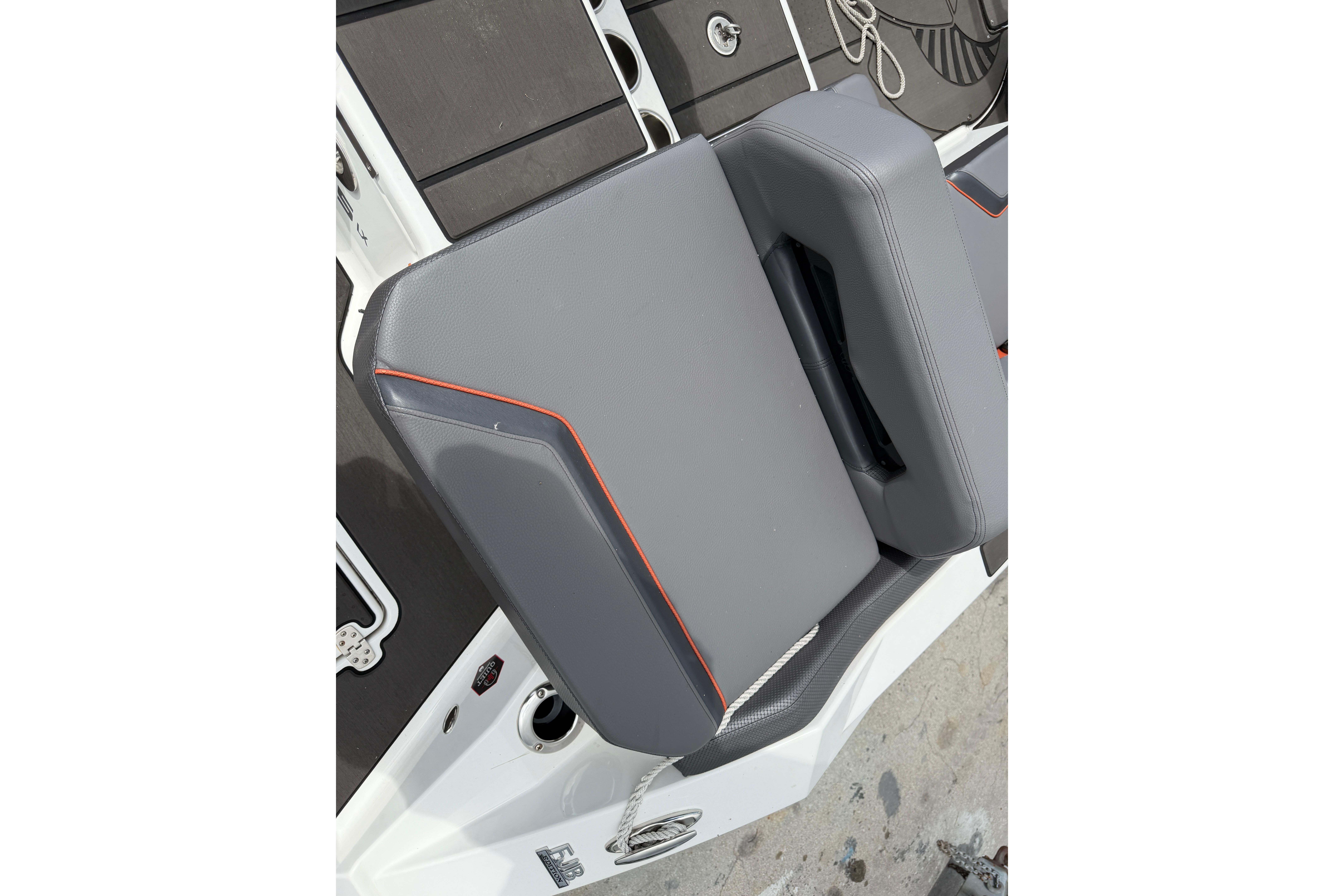 Gray seating on 2026 Scarab 235 LX boat with orange accents and deck view.