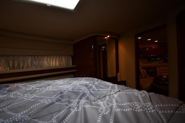 Interior cabin of 2003 Sea Ray 460 Sundancer yacht with bed and ambient lighting.