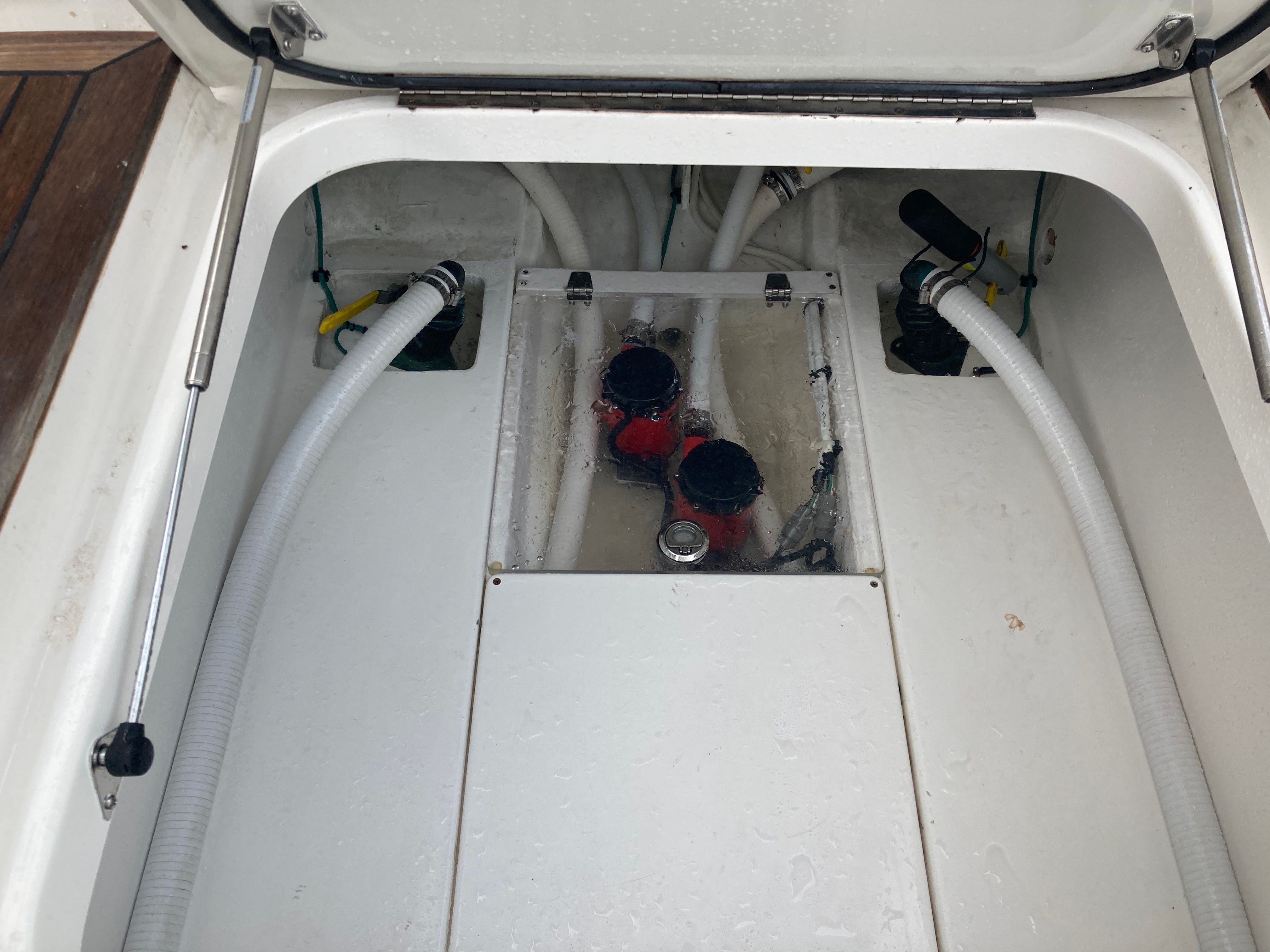 Venture CC 2019 boat engine compartment with hoses and valves.