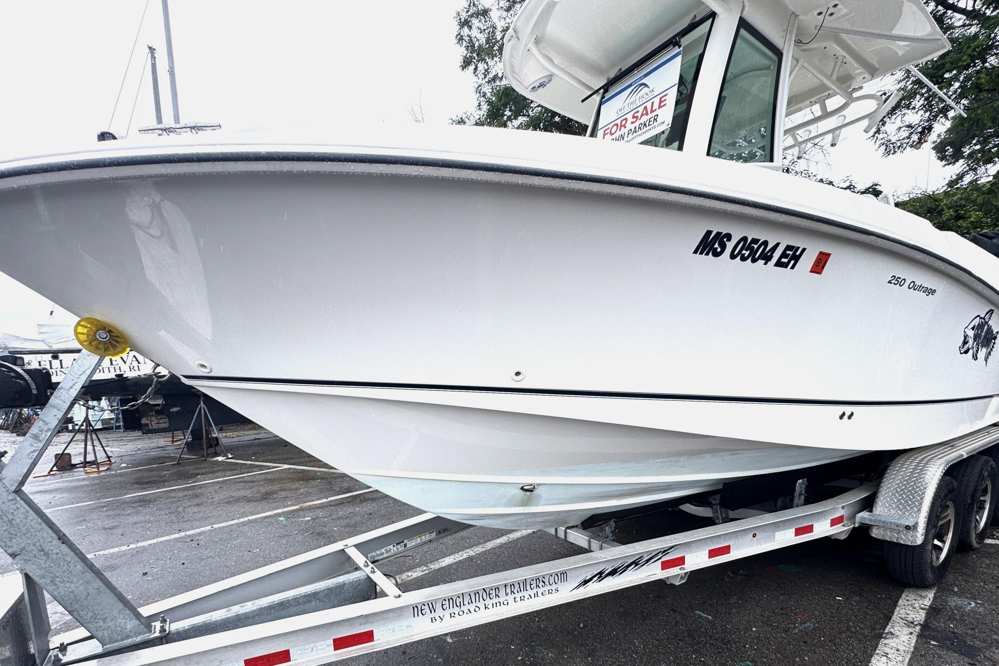 2014 Boston Whaler 250 Outrage boat on trailer, for sale sign visible.