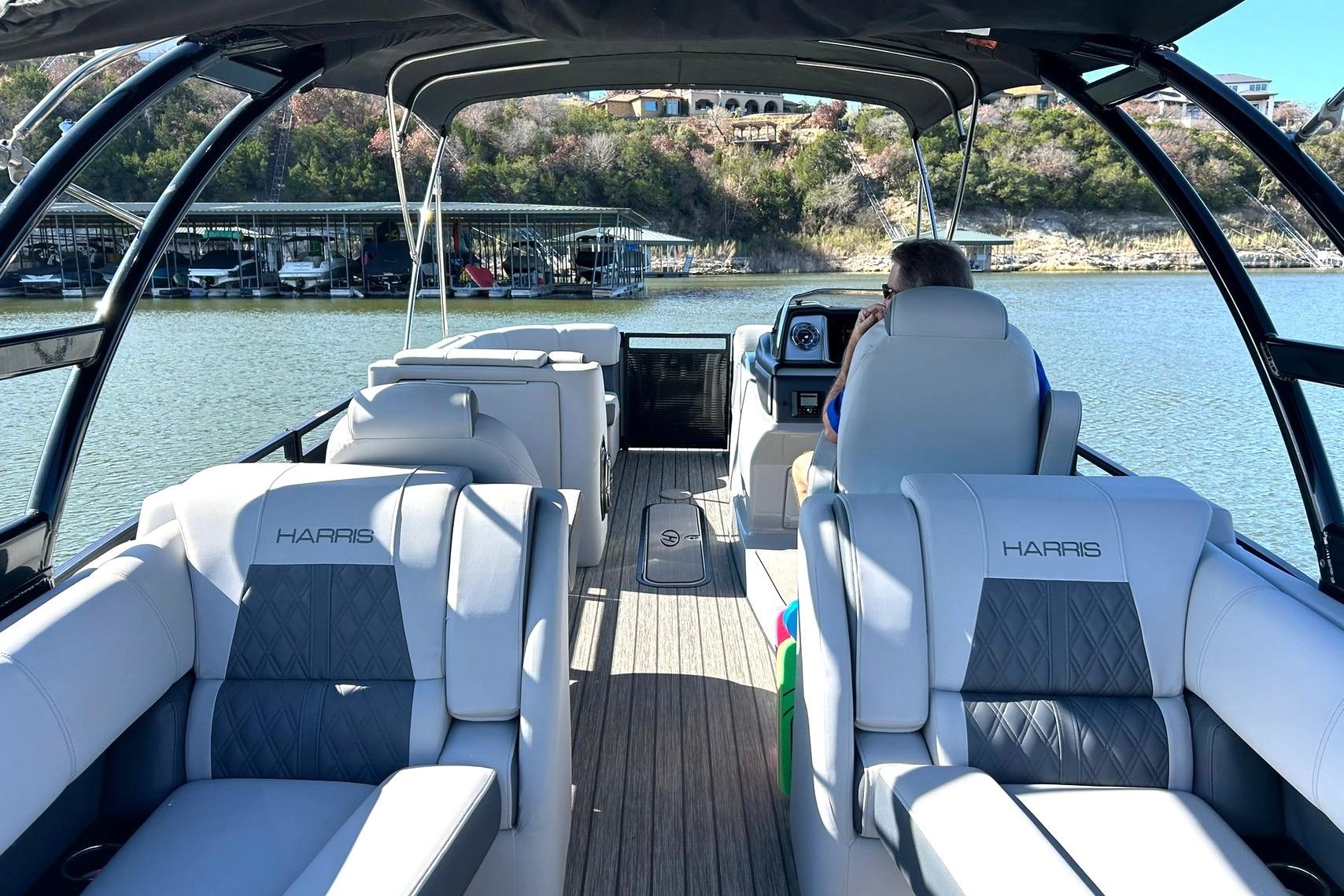 2020 Harris FloteBote Solstice 230 pontoon boat on a scenic lake.