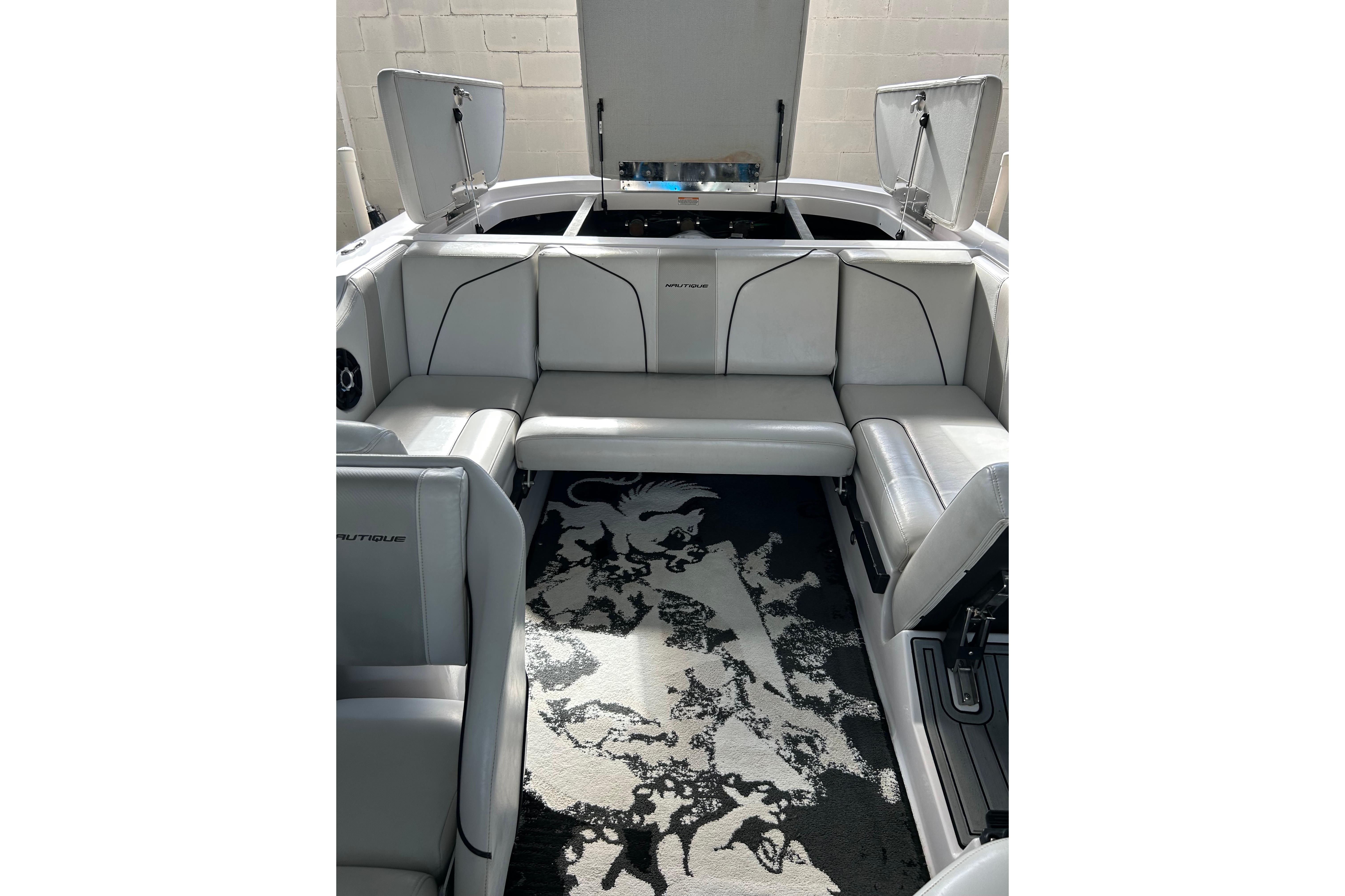 Interior of 2010 Nautique Super Air Nautique 210 Coastal Edition boat, featuring white seating.