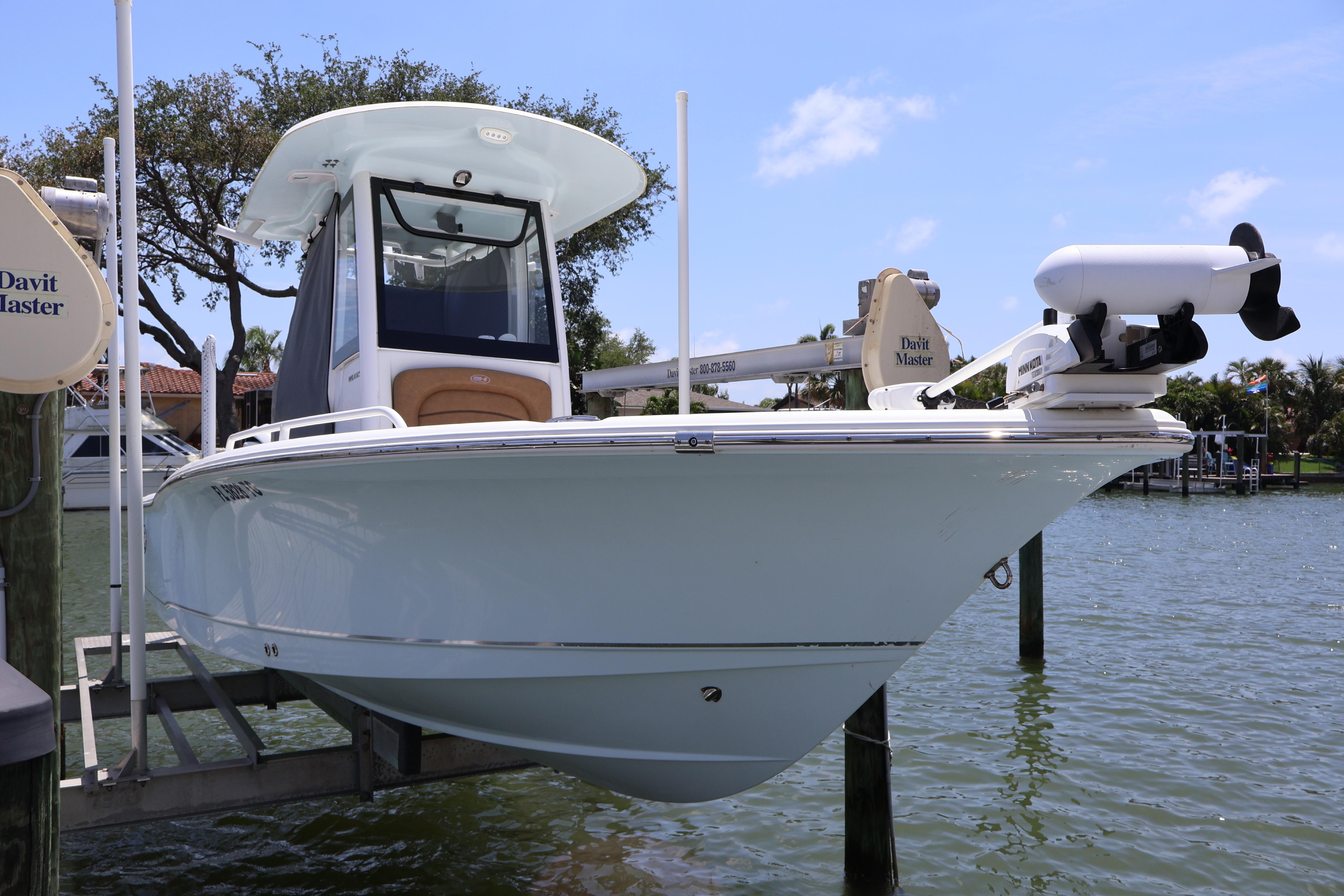 2022 Sea Hunt BX 25 FS boat docked on water under clear sky.