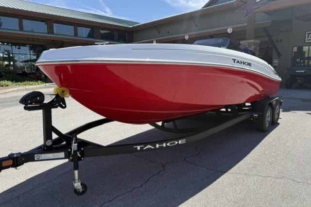 2026 Tahoe T21 boat with red hull on trailer, parked outdoors.