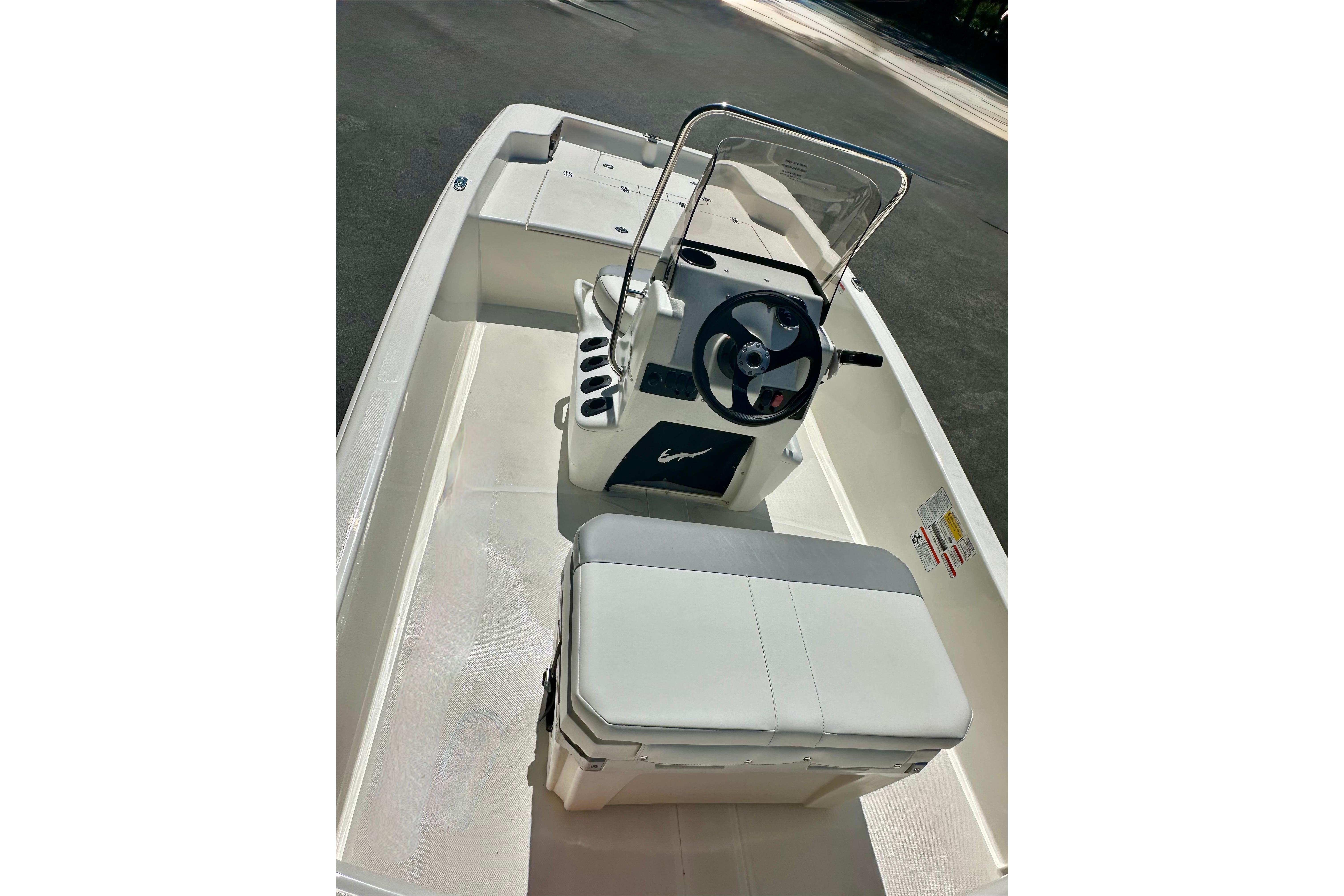 2026 Mako Pro Skiff 15 CC boat interior with steering console and seating.