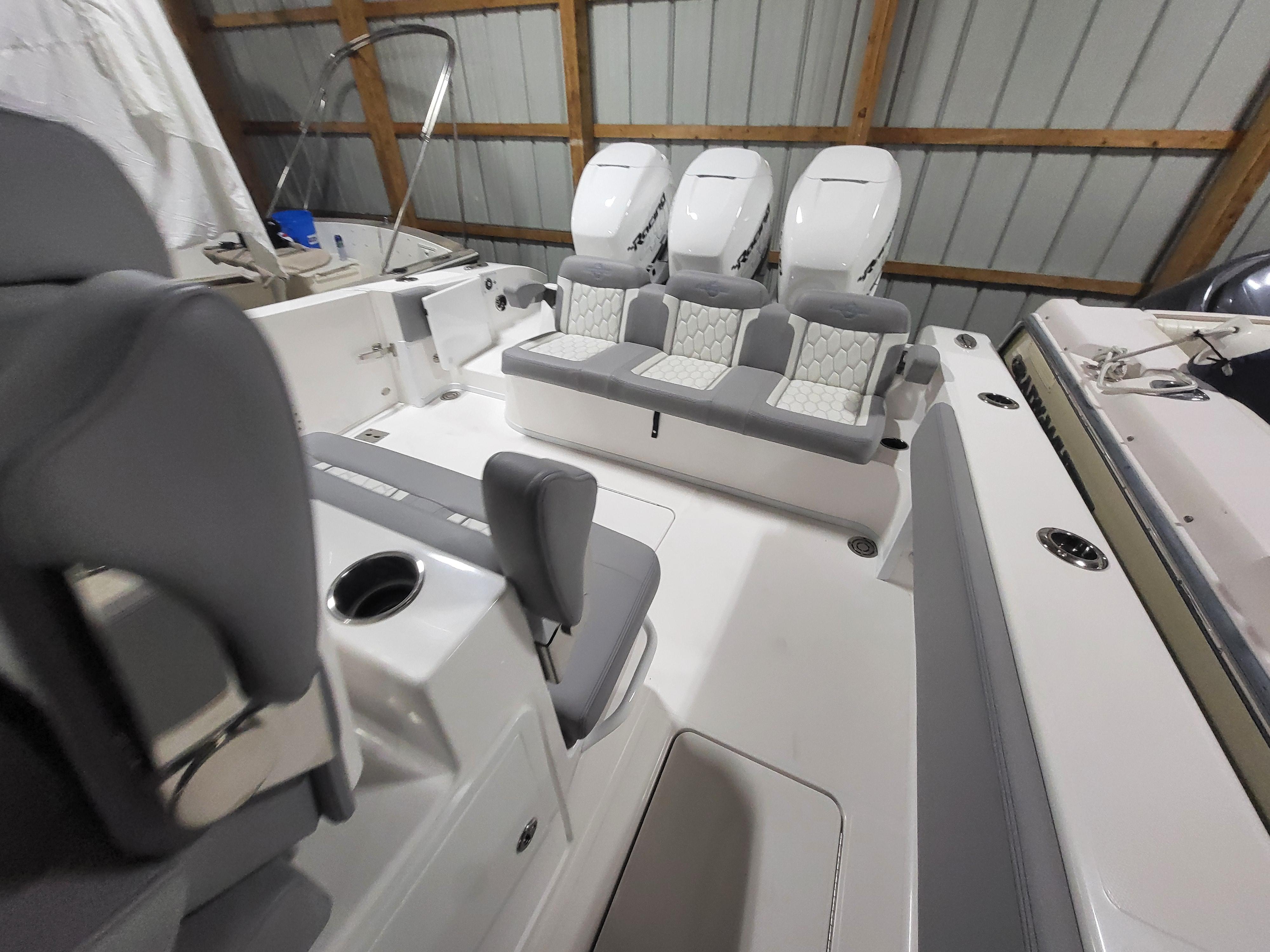 2022 Fountain 38 SC boat interior with triple engines and seating in a storage facility.