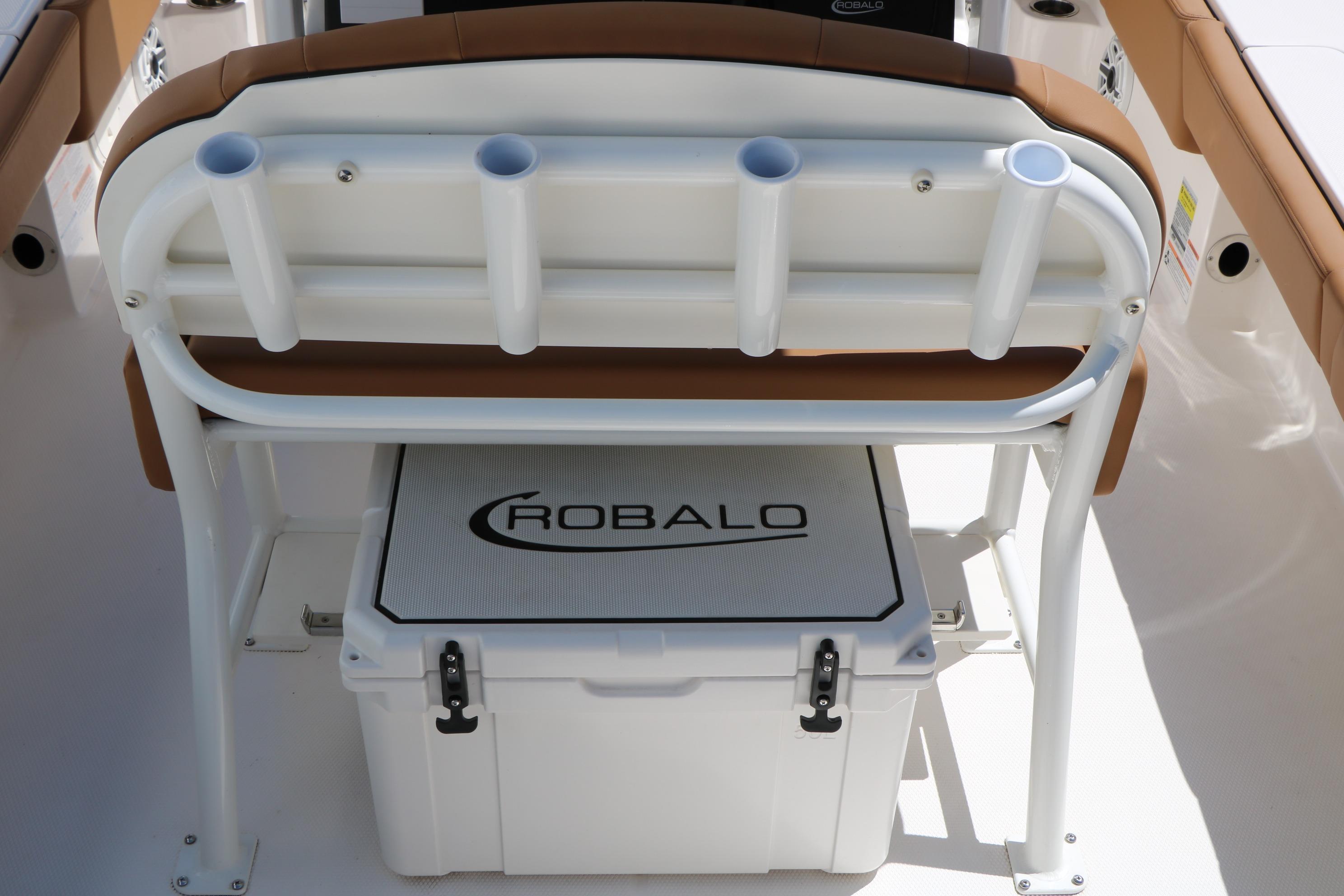 2026 Robalo 246 Cayman boat interior with rod holders and cooler.