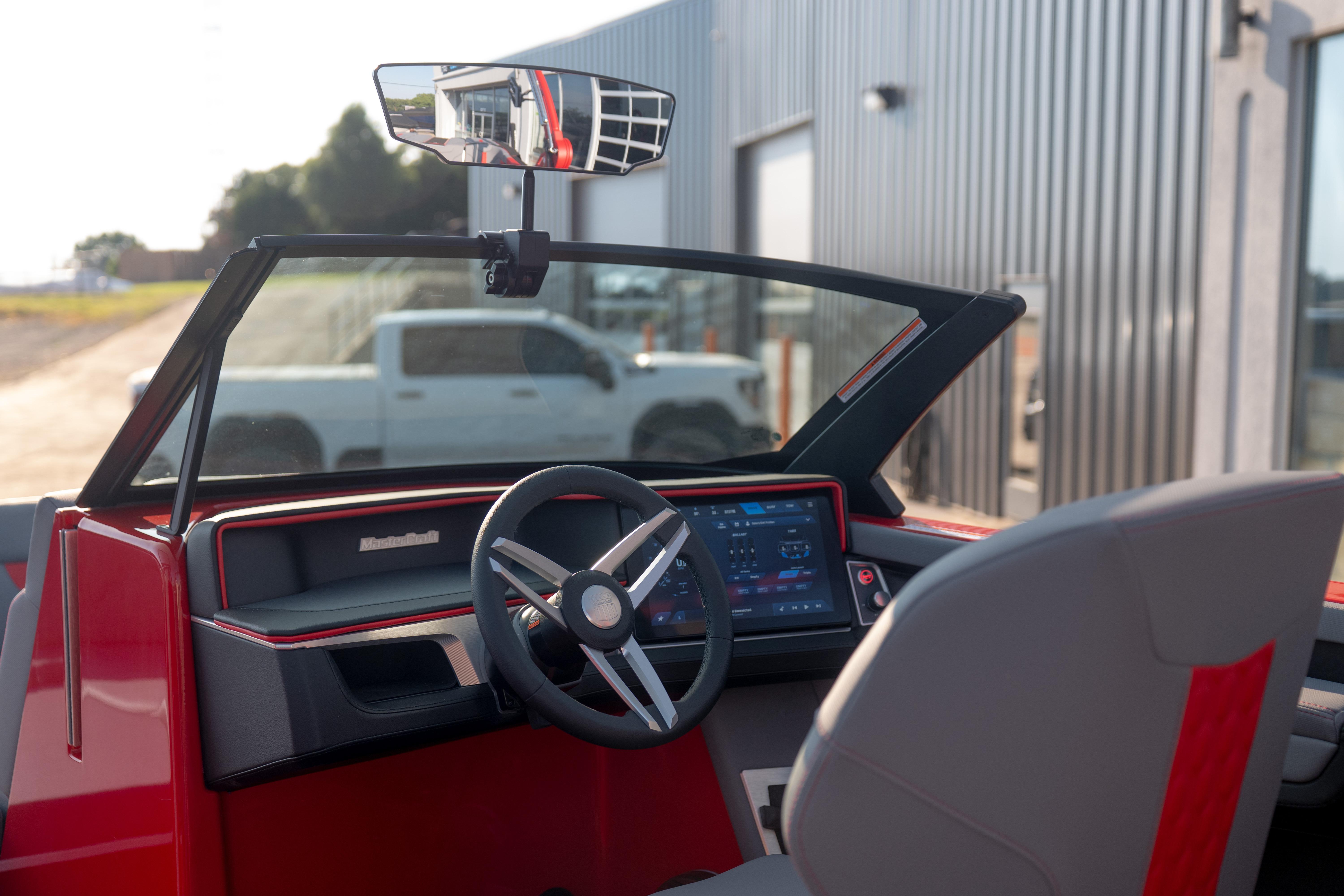 Interior view of 2027 MasterCraft XT24 boat with modern dashboard and steering wheel.