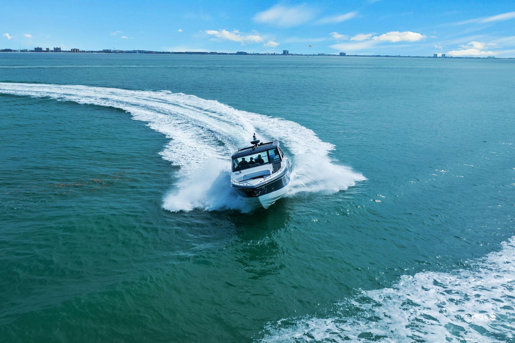2023 Formula 380 Super Sport Crossover OB cruising on open water, creating a dynamic wake.