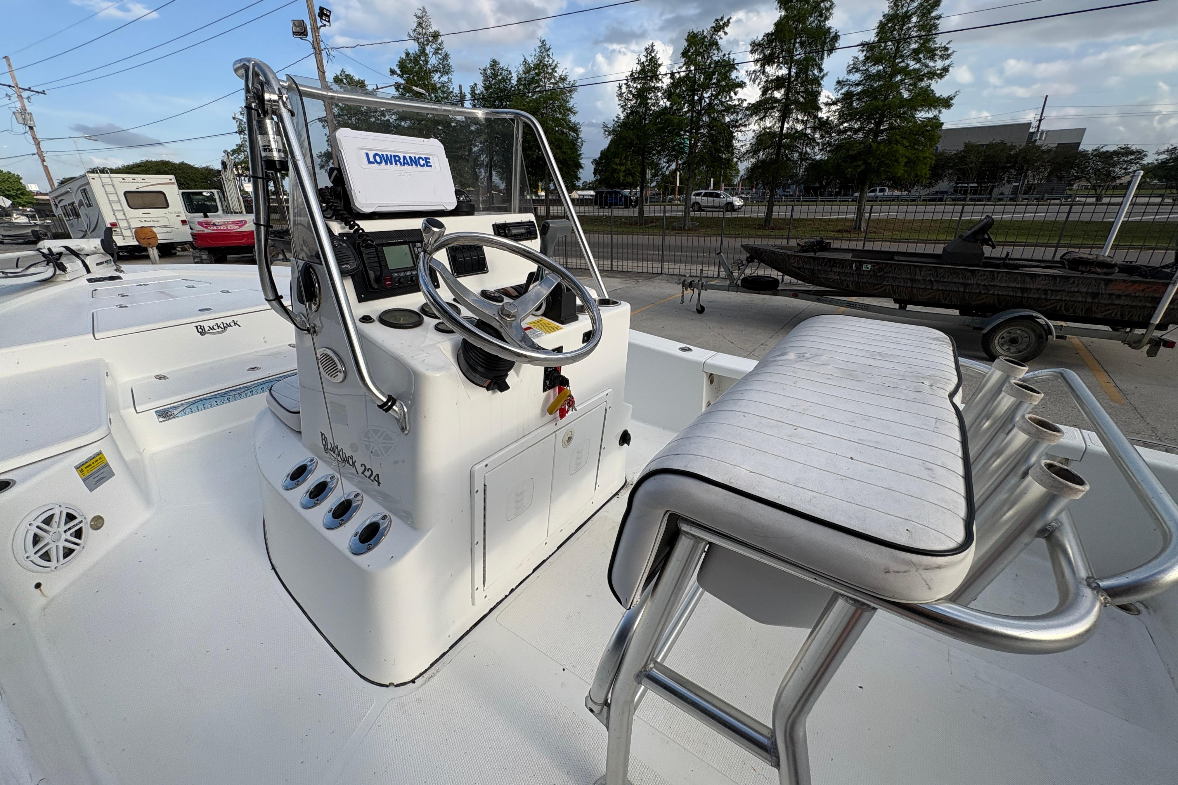 2012 BlackJack 224 boat cockpit with steering wheel and Lowrance navigation system.