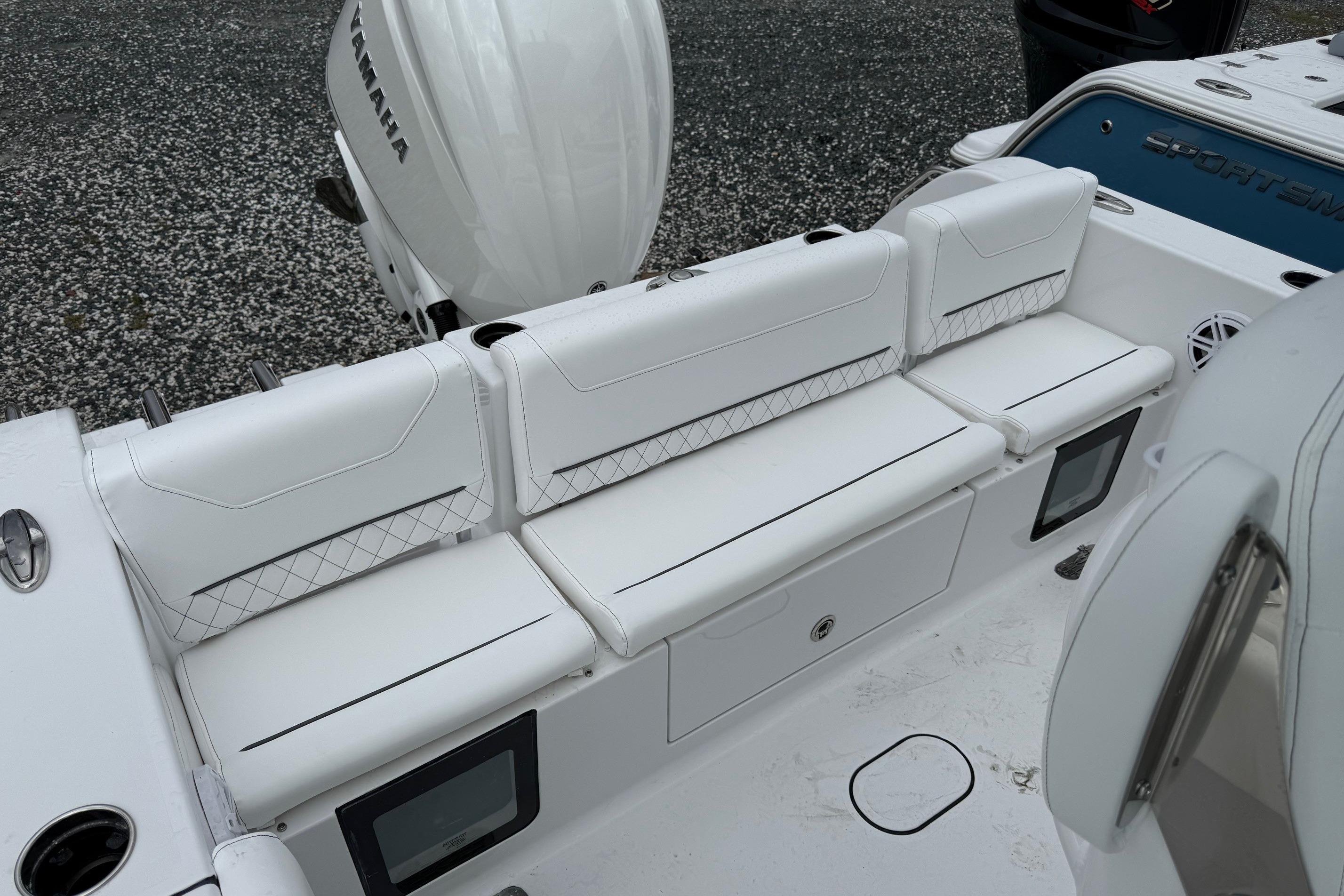 2026 Sportsman Heritage 231 Center Console boat with white cushioned seating and Yamaha engine.