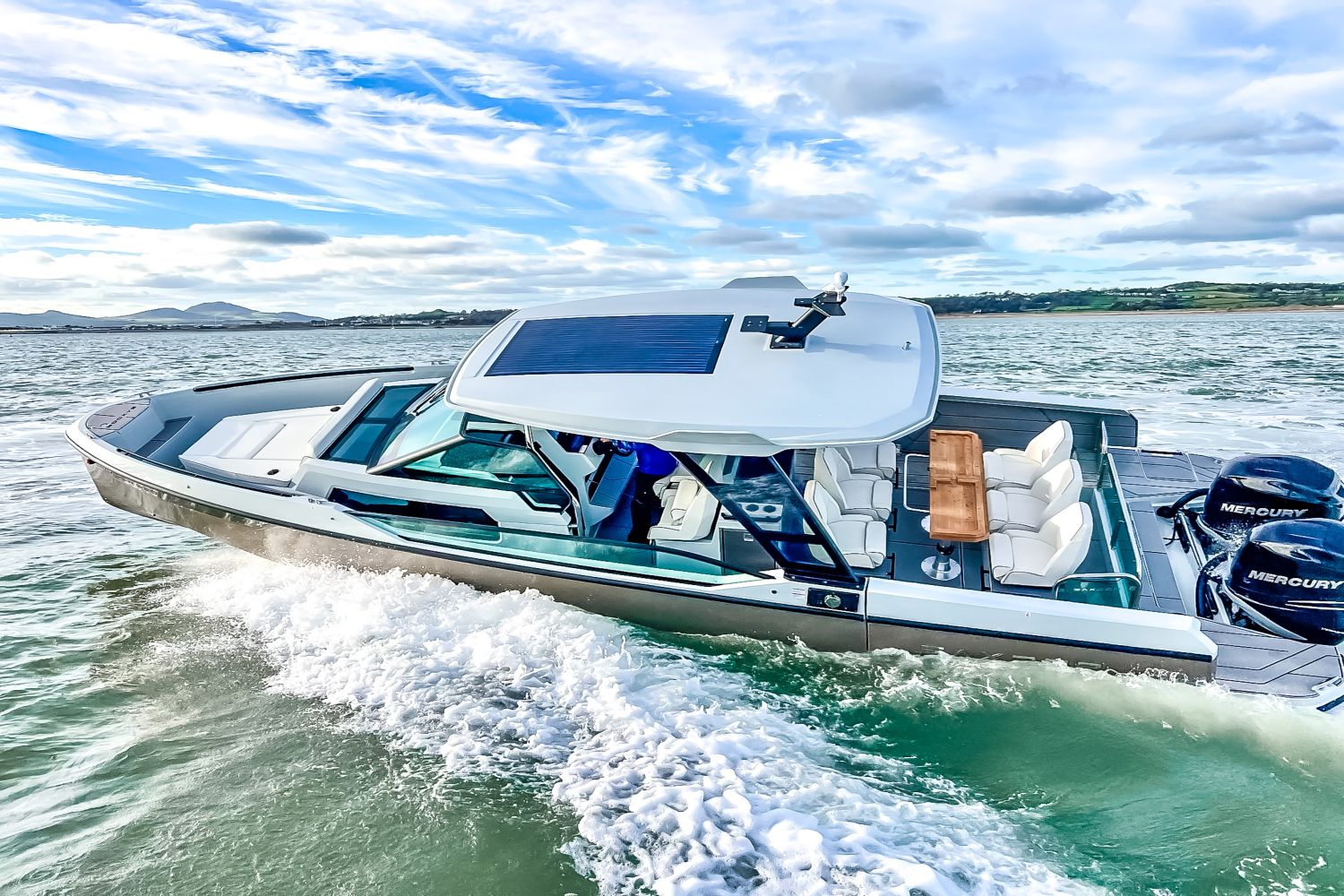 A 2027 Saxdor SX320 GTO cruising on the water. It features a modern design and twin outboard engines.