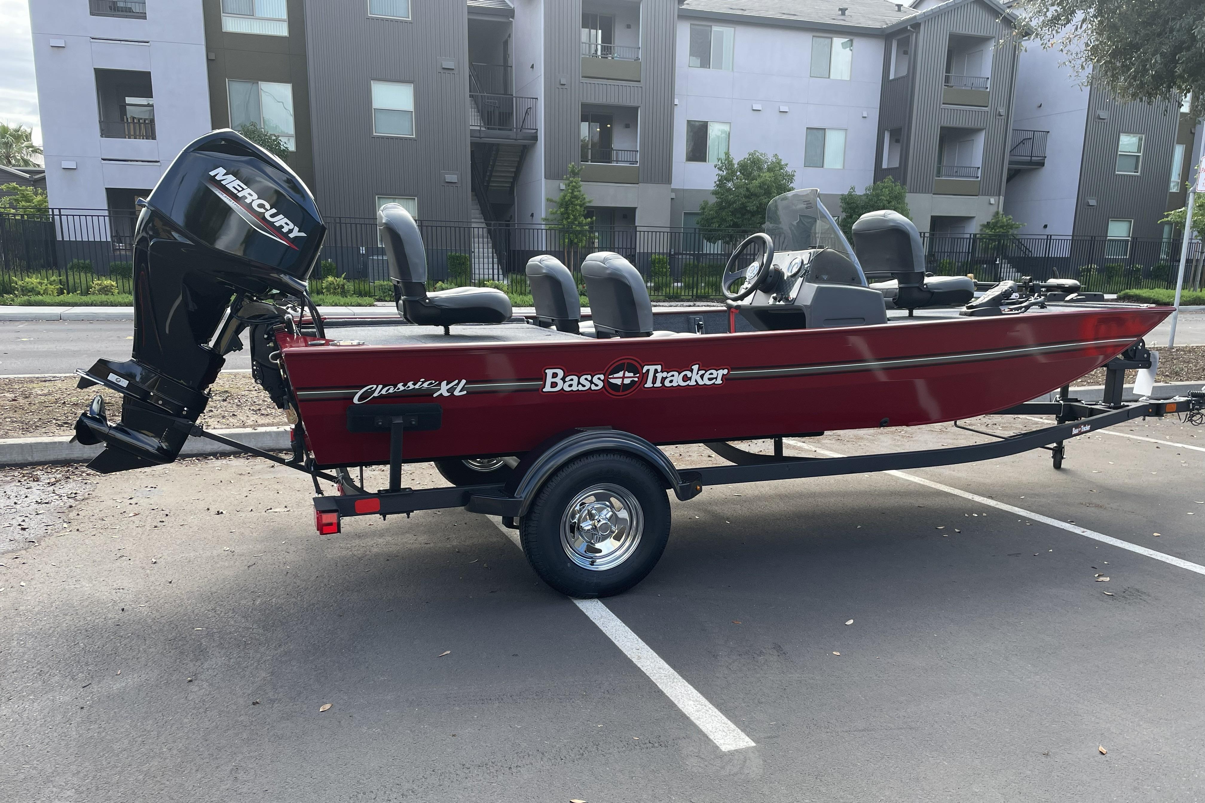 2026 Tracker Bass Tracker Classic XL boat with Mercury engine in parking lot.