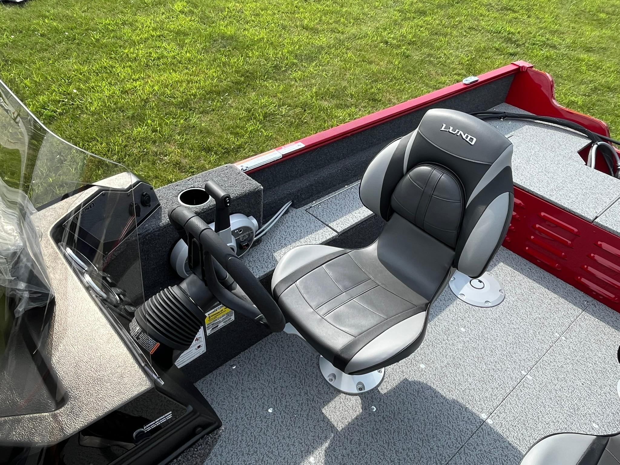 2026 Lund 1650 Angler SS boat interior with steering wheel and cushioned seat.