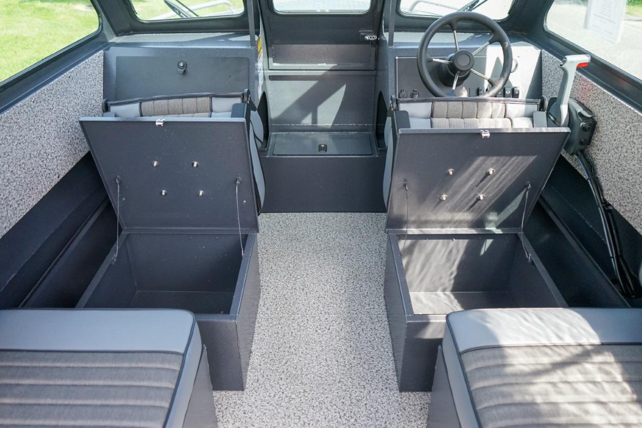 2026 Alumaweld X202 Stryker boat interior with open storage compartments and steering wheel.