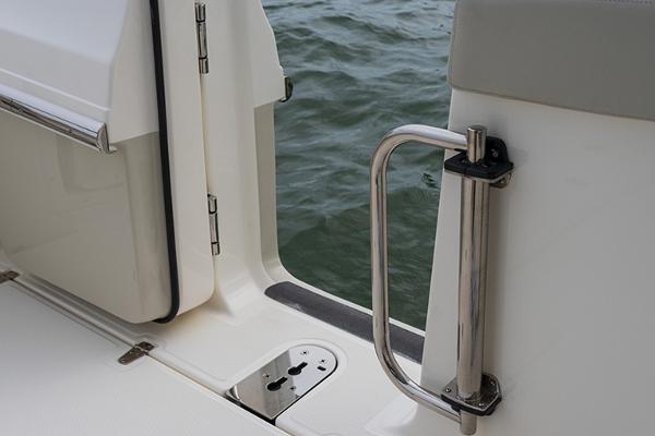 Manufacturer Provided Image: 2026 Boston Whaler 280 Vantage boat door with stainless steel handle, open to water view.