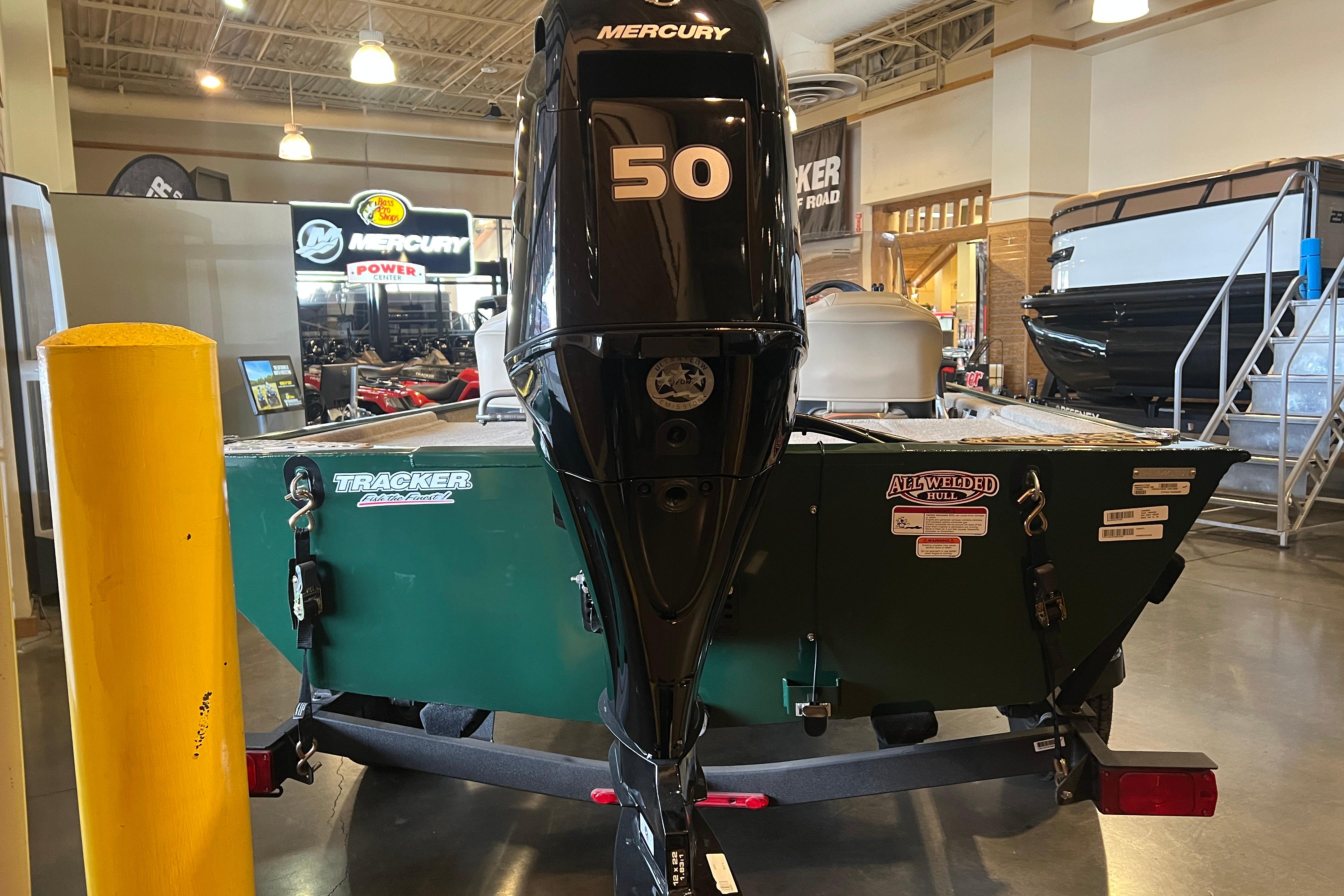 2026 Tracker Bass Tracker Classic Limited boat with Mercury 50 engine in showroom.