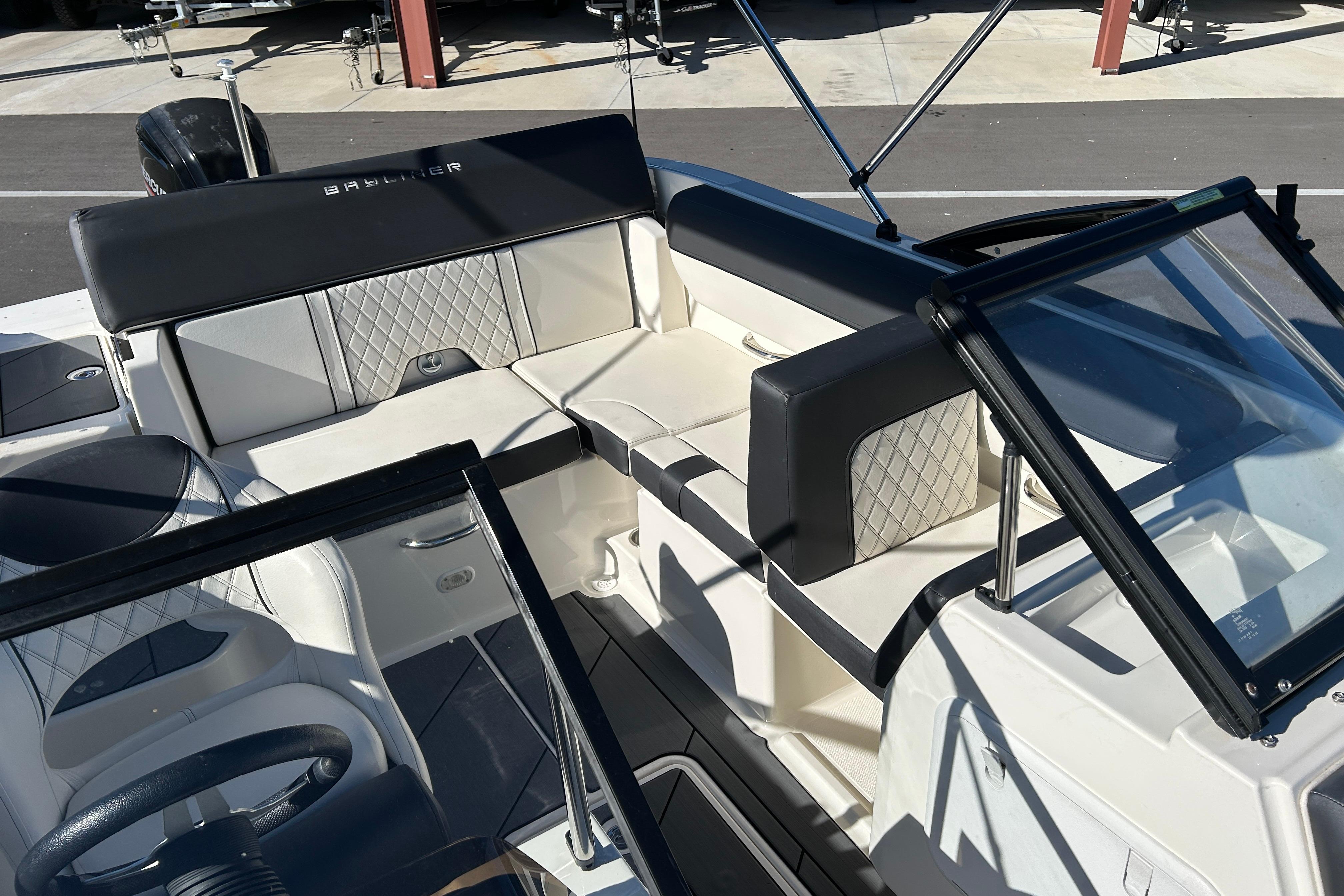 2020 Bayliner DX 2000 boat interior with cushioned seating and windshield.