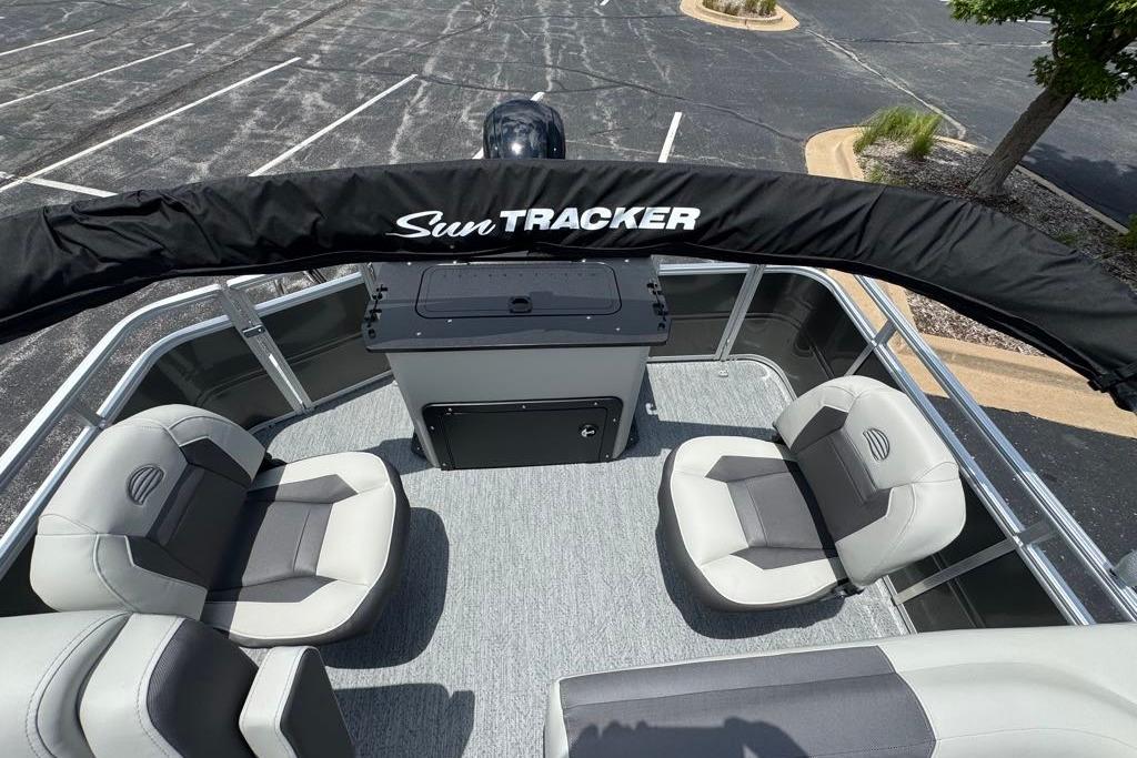 2026 Sun Tracker Fishin' Barge 20 DLX interior with seating and console.