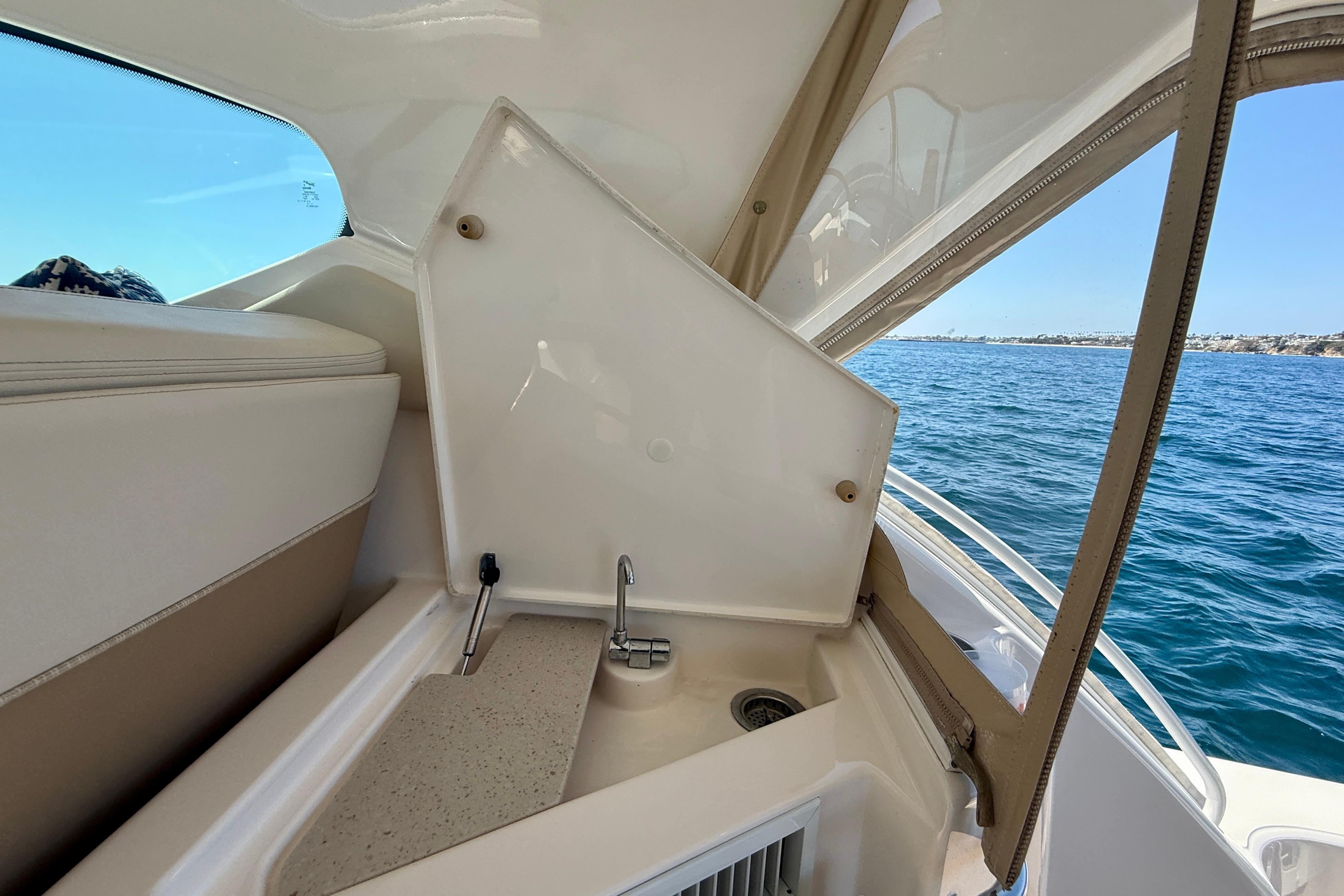 Interior view of 2012 Tiara Yachts 4500 Sovran with sink and ocean backdrop.