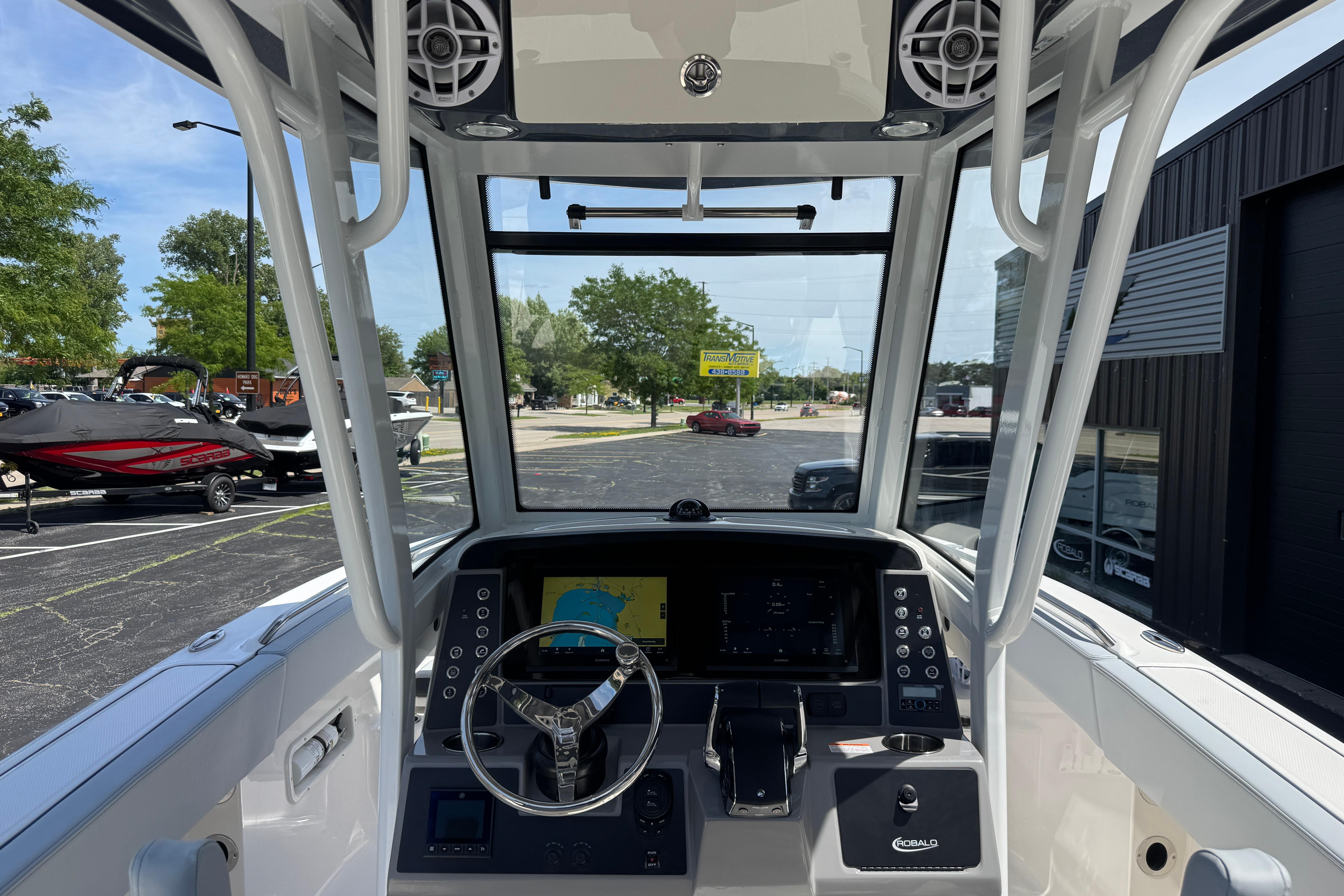 2026 Robalo R250 Center Console boat dashboard with steering wheel and navigation display.
