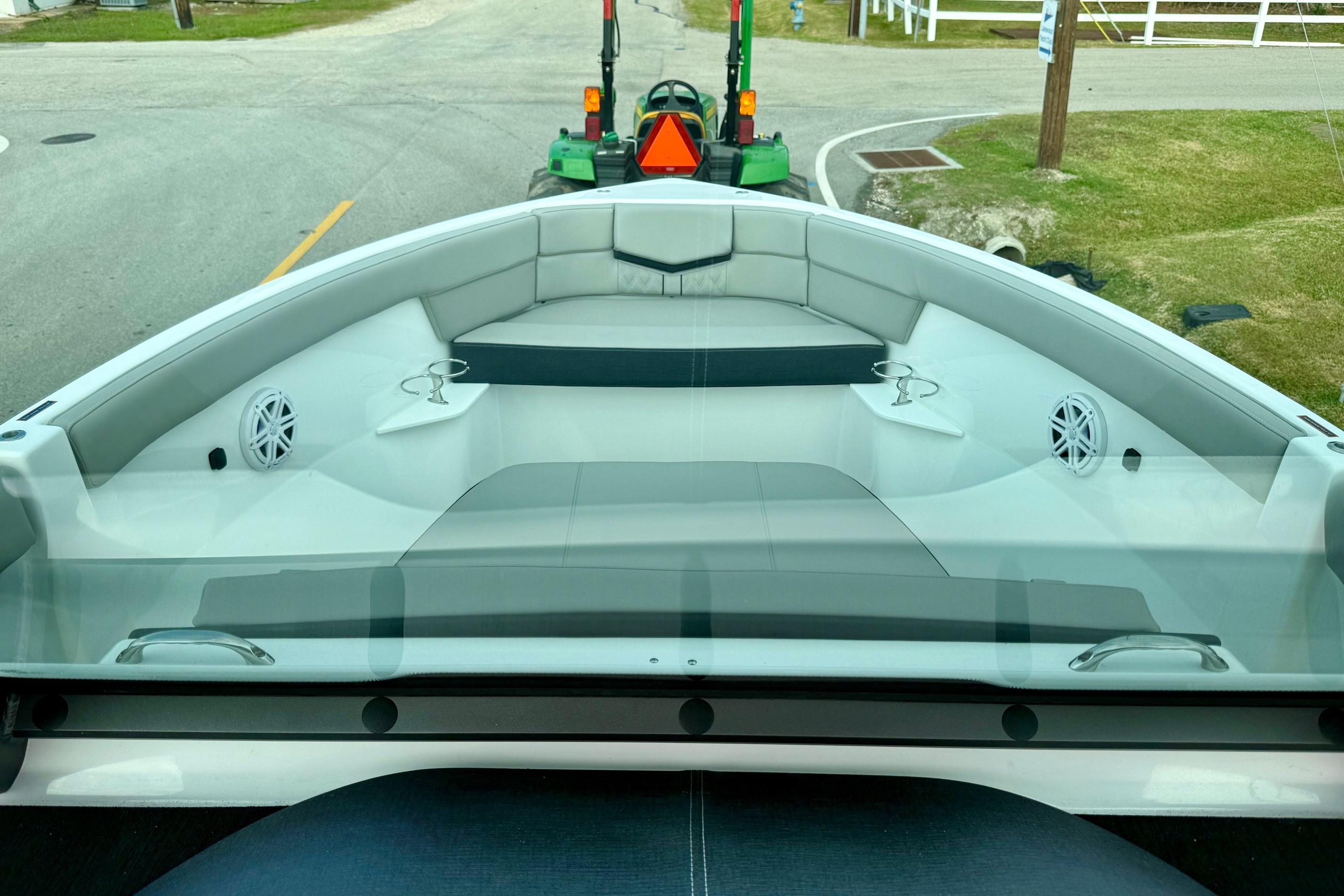 2026 Monterey Elite 25 OB boat interior with seating and cup holders.