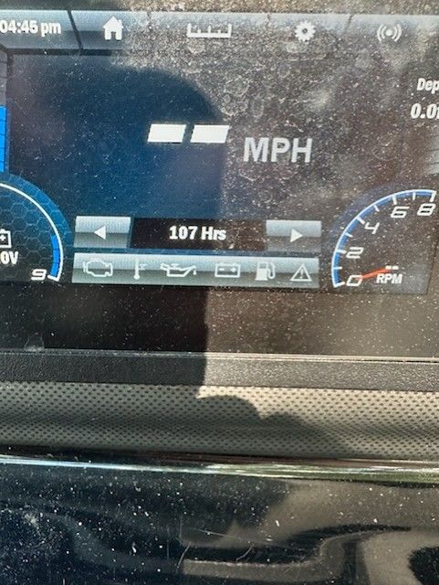 Close-up of a boat dashboard showing speed and engine hours.