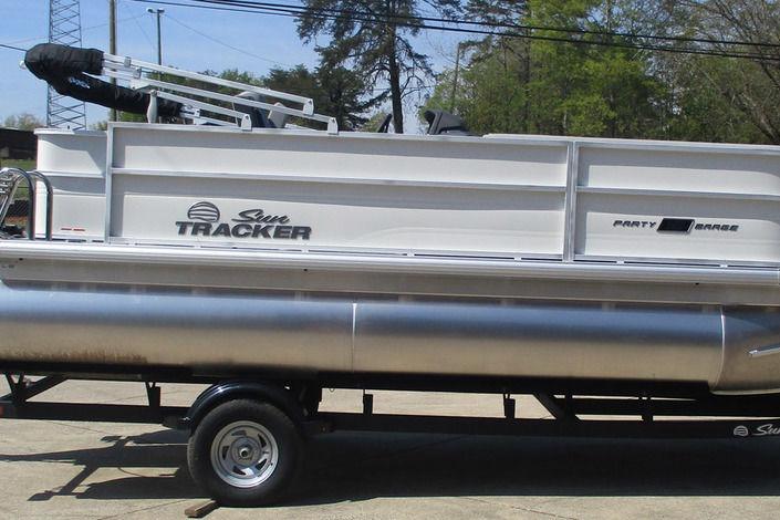 2026 Sun Tracker Party Barge 18 DLX pontoon boat on trailer, side view.