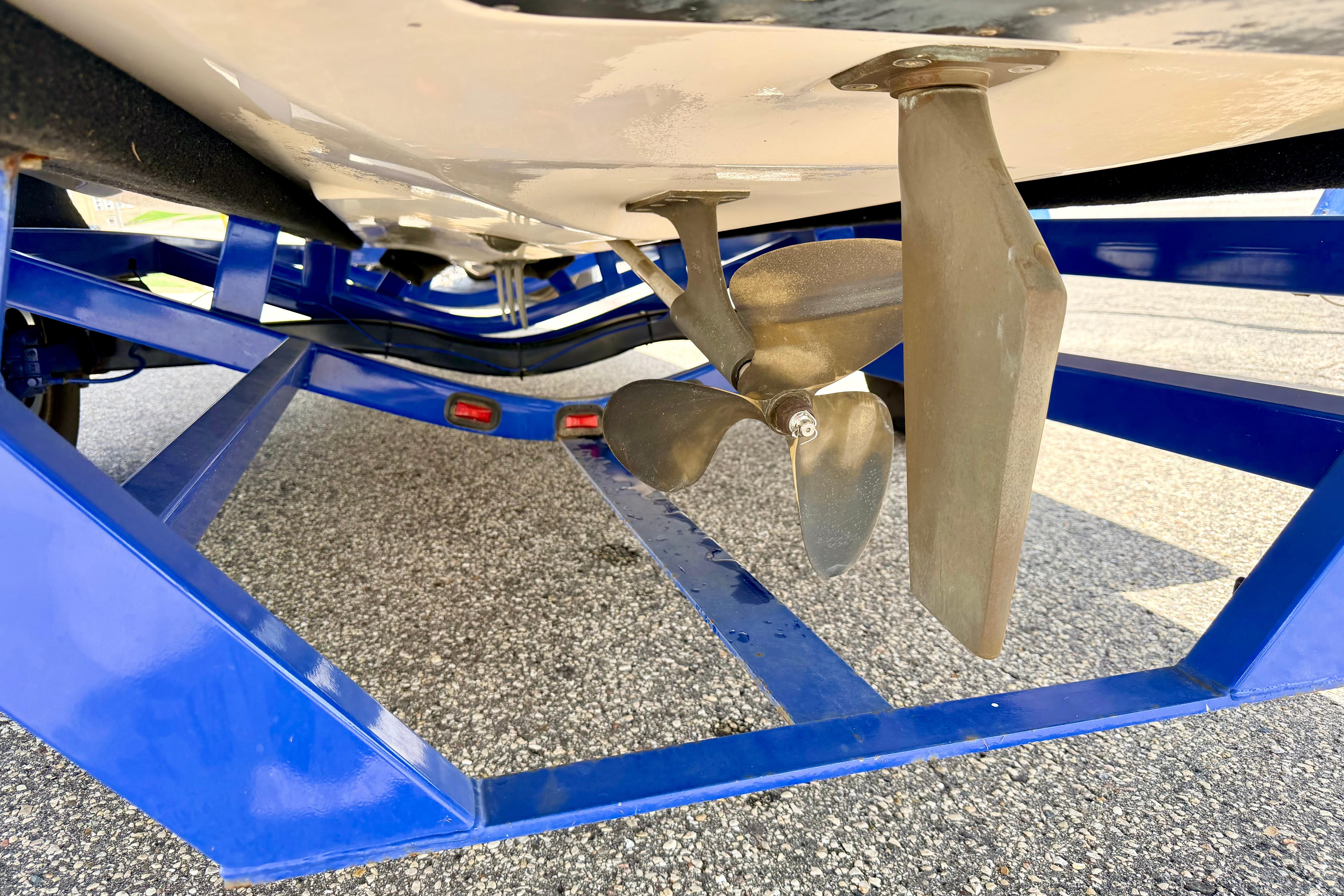2008 Moomba Outback V boat propeller and rudder on blue trailer.