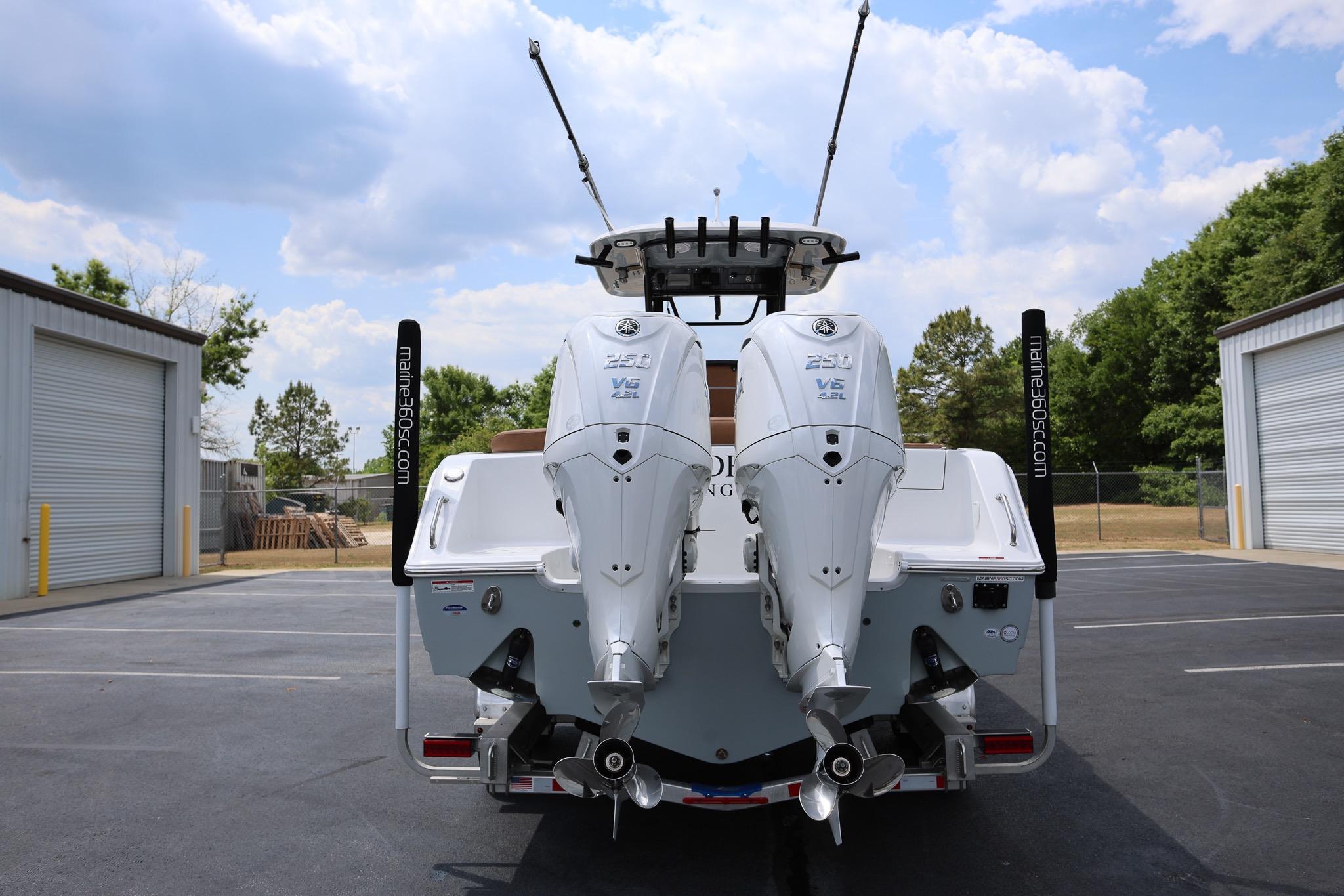 2024 Sea Hunt Ultra 275 SE boat with dual outboard engines in a parking lot.