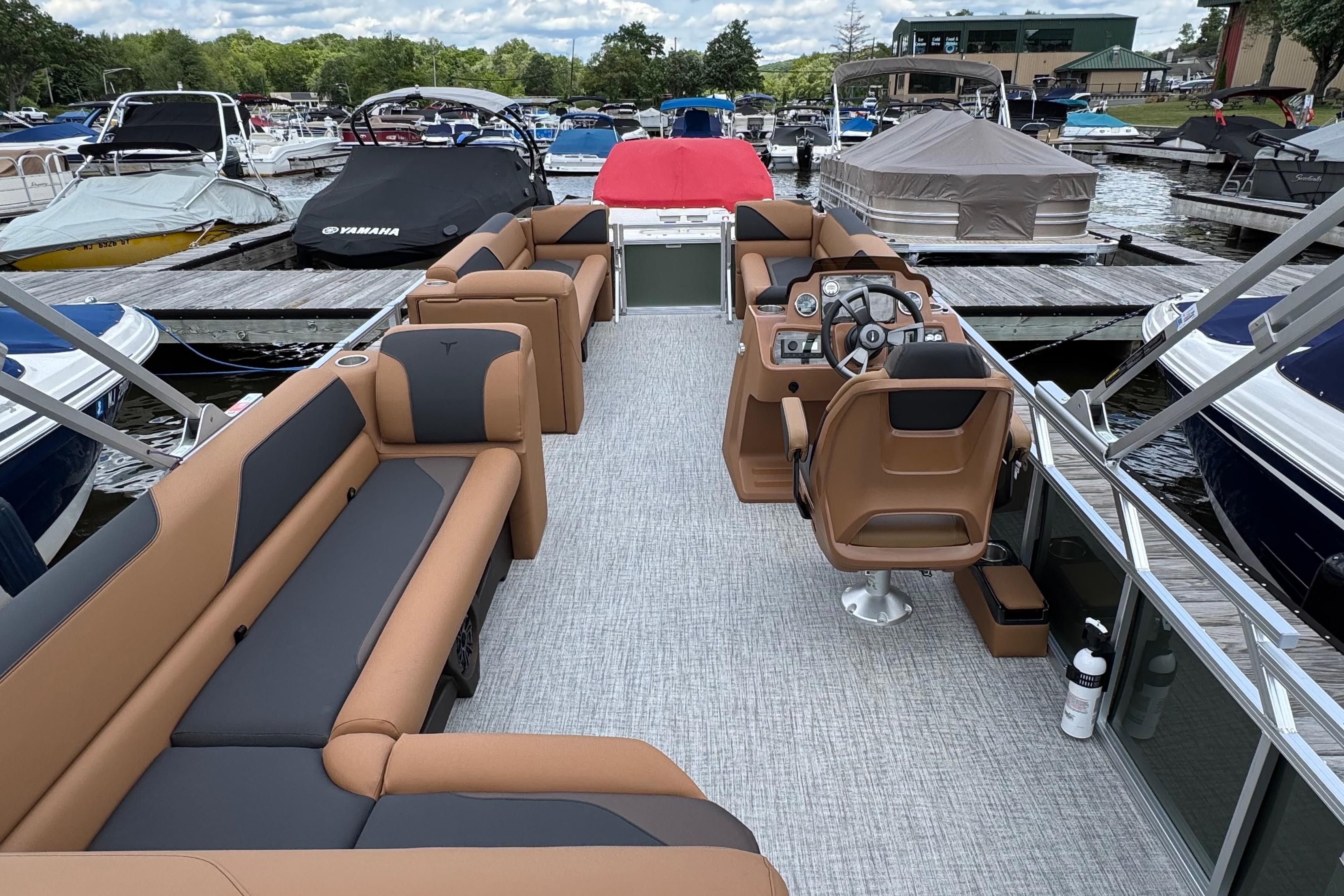 2026 Tahoe Pontoon Sport 85 Cruise Rear Bench 23 at marina, featuring luxurious seating and helm.