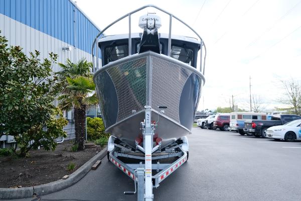2024 Hewescraft 250 Explorer boat on trailer in parking lot.