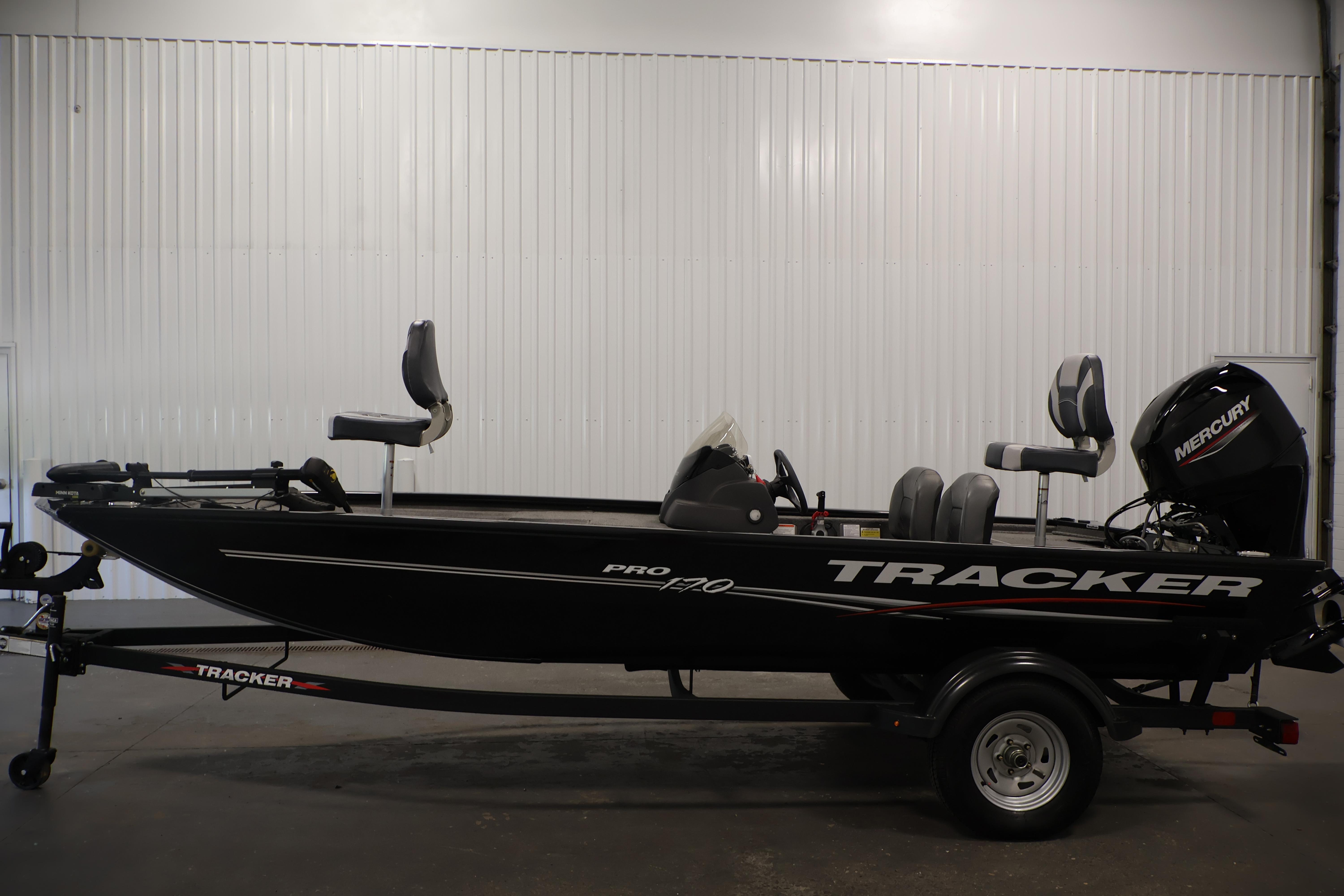 2024 Tracker Pro 170 fishing boat with Mercury engine, displayed indoors on a trailer.